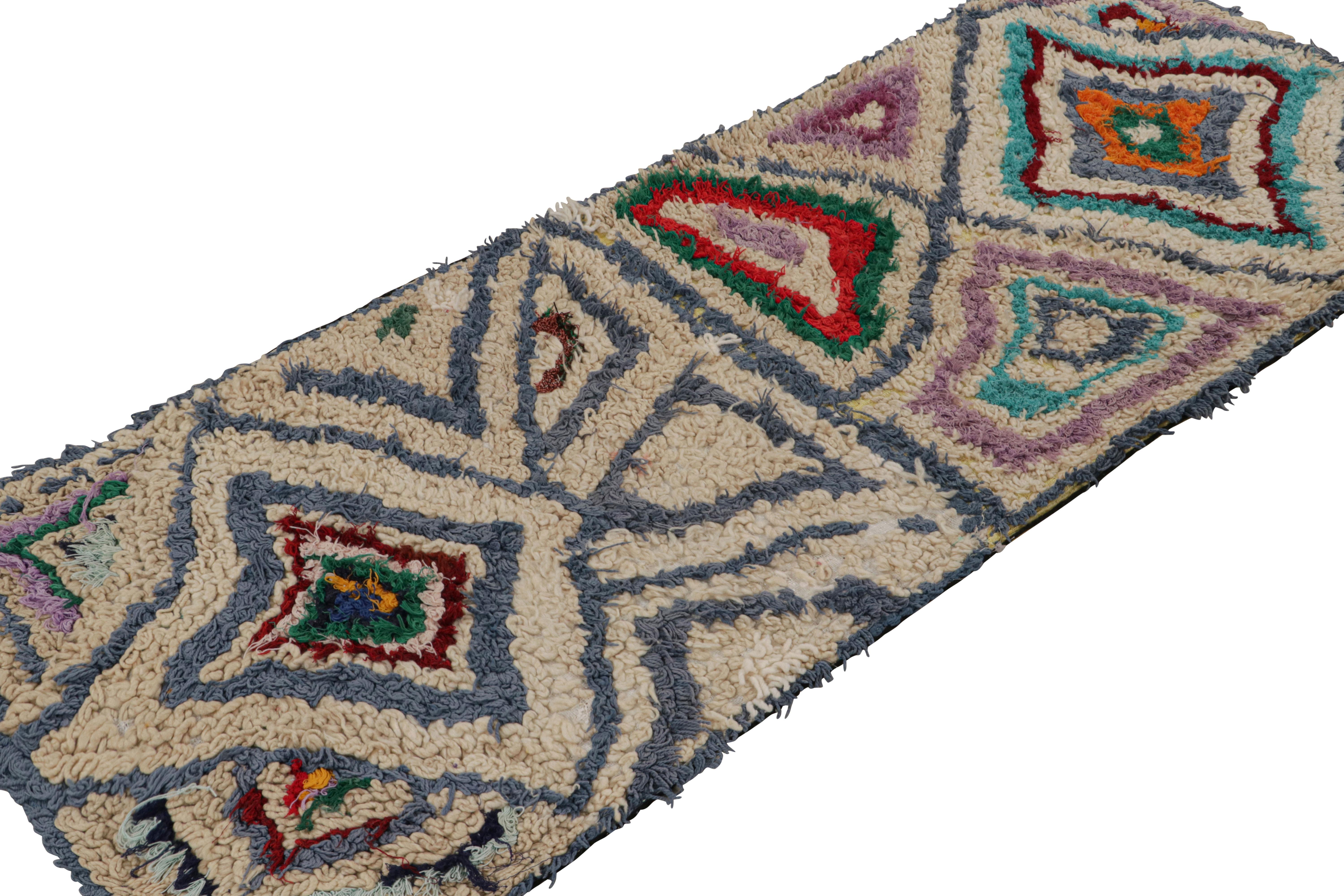 Hand-knotted in wool circa 1950-1960, this 3x7 vintage Moroccan runner rug with polychromatic diamond medallions, hails from the Azilal tribe.  

On the Design: 

This is an exemplary piece of the playful, bright nature and textural beauty that
