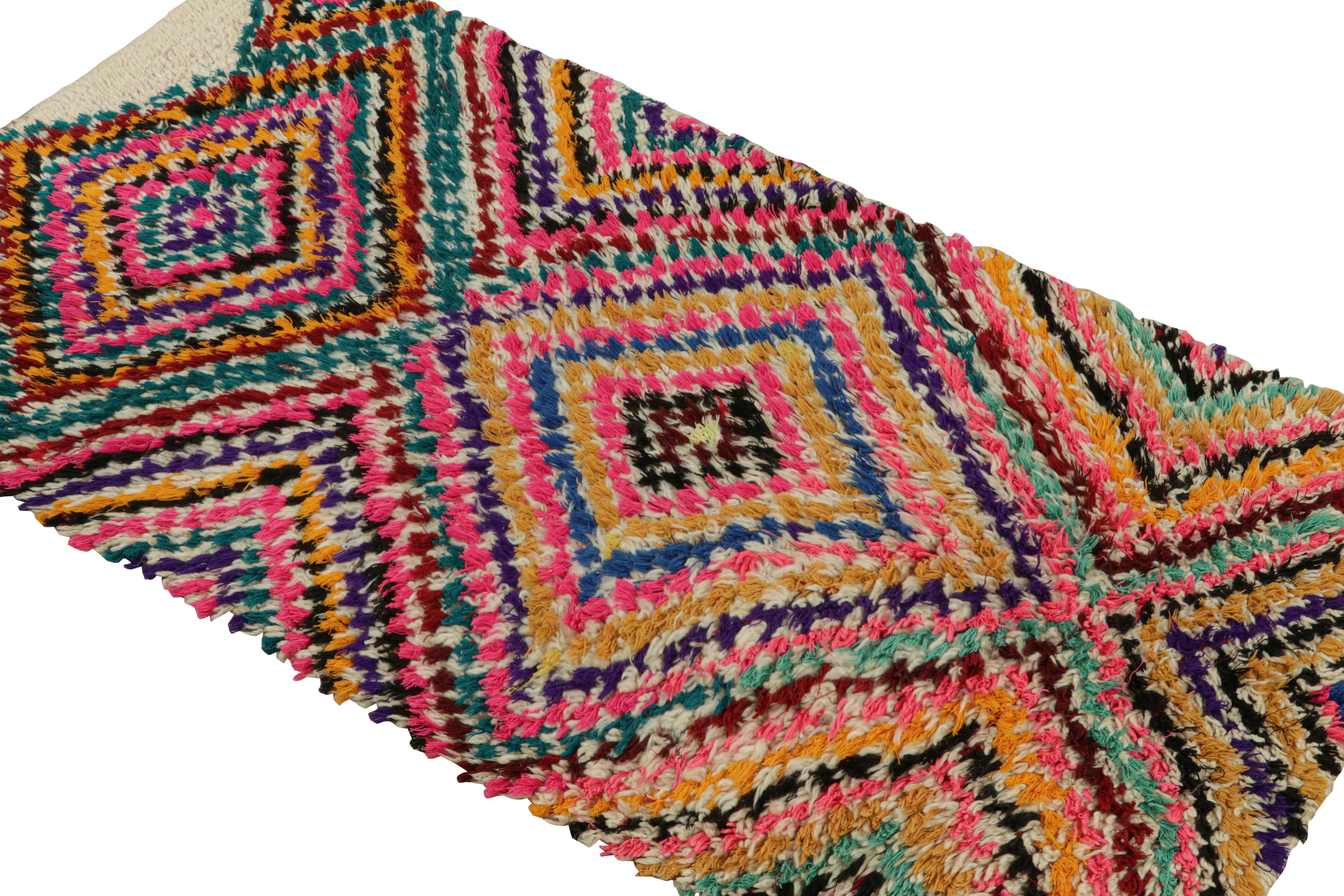 Hand-knotted in wool circa 1950-1960, this 3x6 vintage Moroccan runner rug with polychromatic diamond medallions, hails from the Azilal tribe.  

On the Design: 

This piece enjoys a lush high pile with polychromatic primitivist Berber geometric
