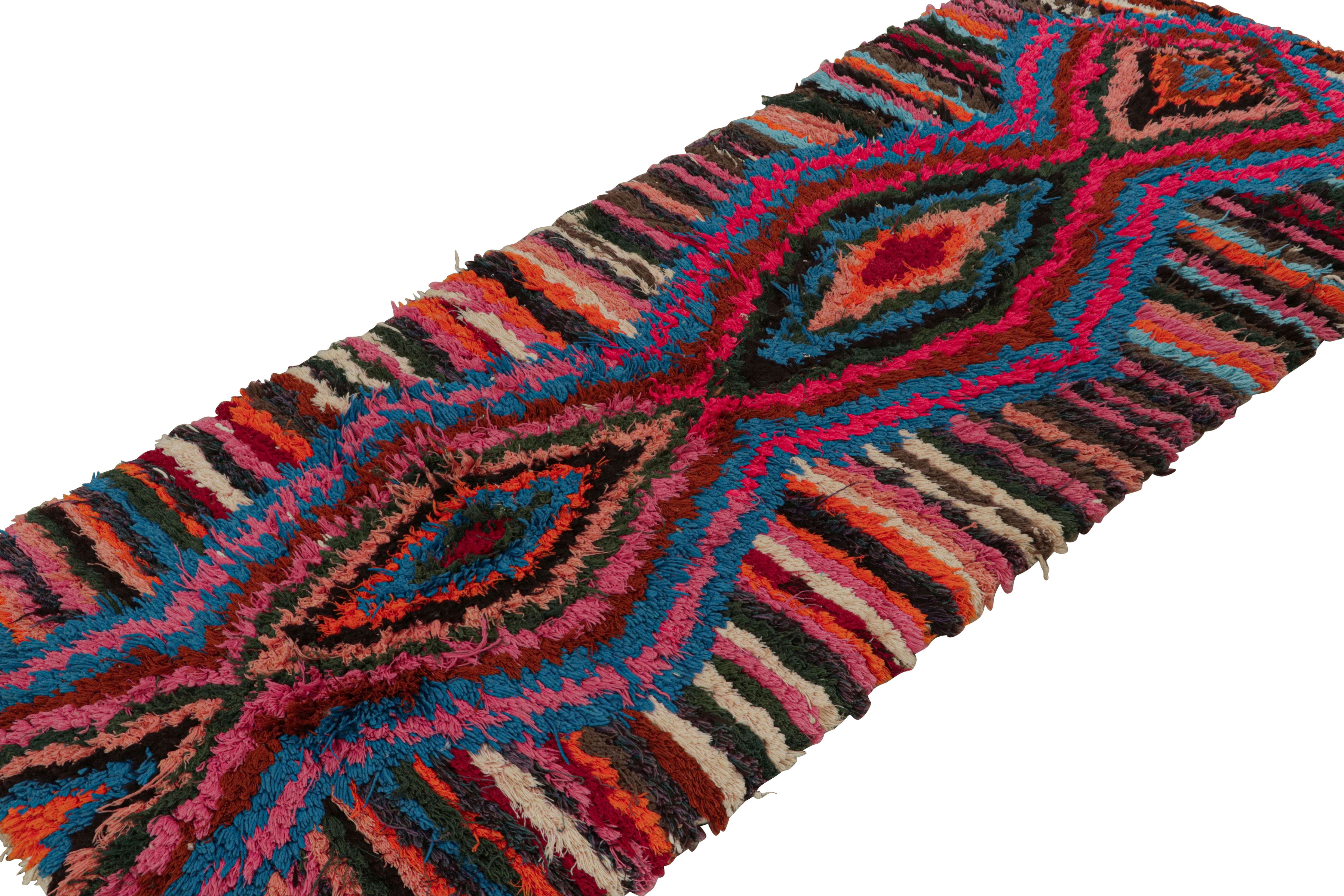 Hand-knotted in wool circa 1950-1960, this 3x6 vintage Moroccan runner rug with polychromatic diamond medallions and geometric stripes, hails from the Azilal tribe.  

On the Design: 

This is an exemplary piece of the playful, bright nature and