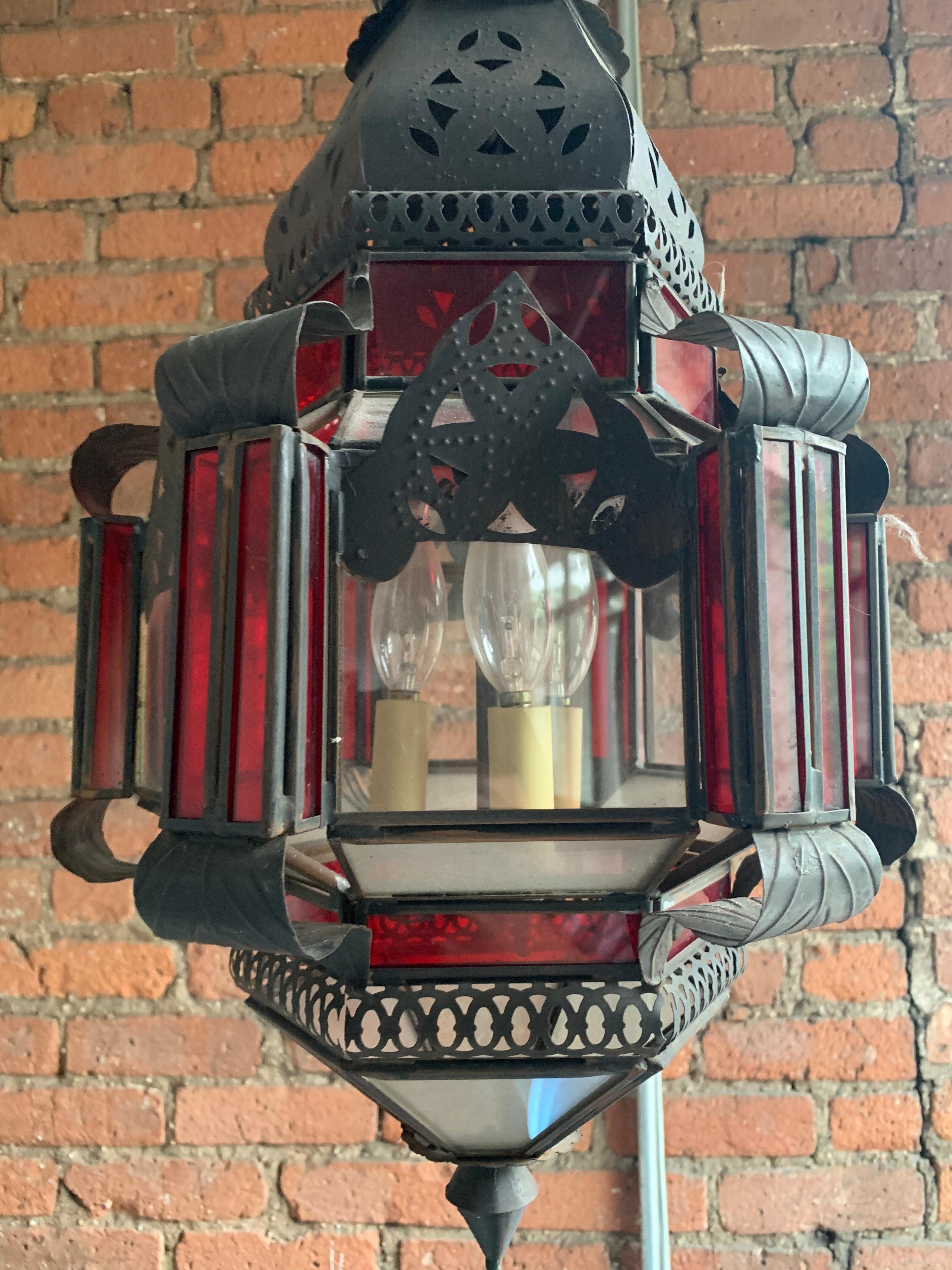 Vintage hand blown glass Moroccan light fixture. The piece has a patinated copper finish with hand blown clear and scarlet glass and pierced metal details.

Property from esteemed interior designer Juan Montoya. Juan Montoya is one of the most