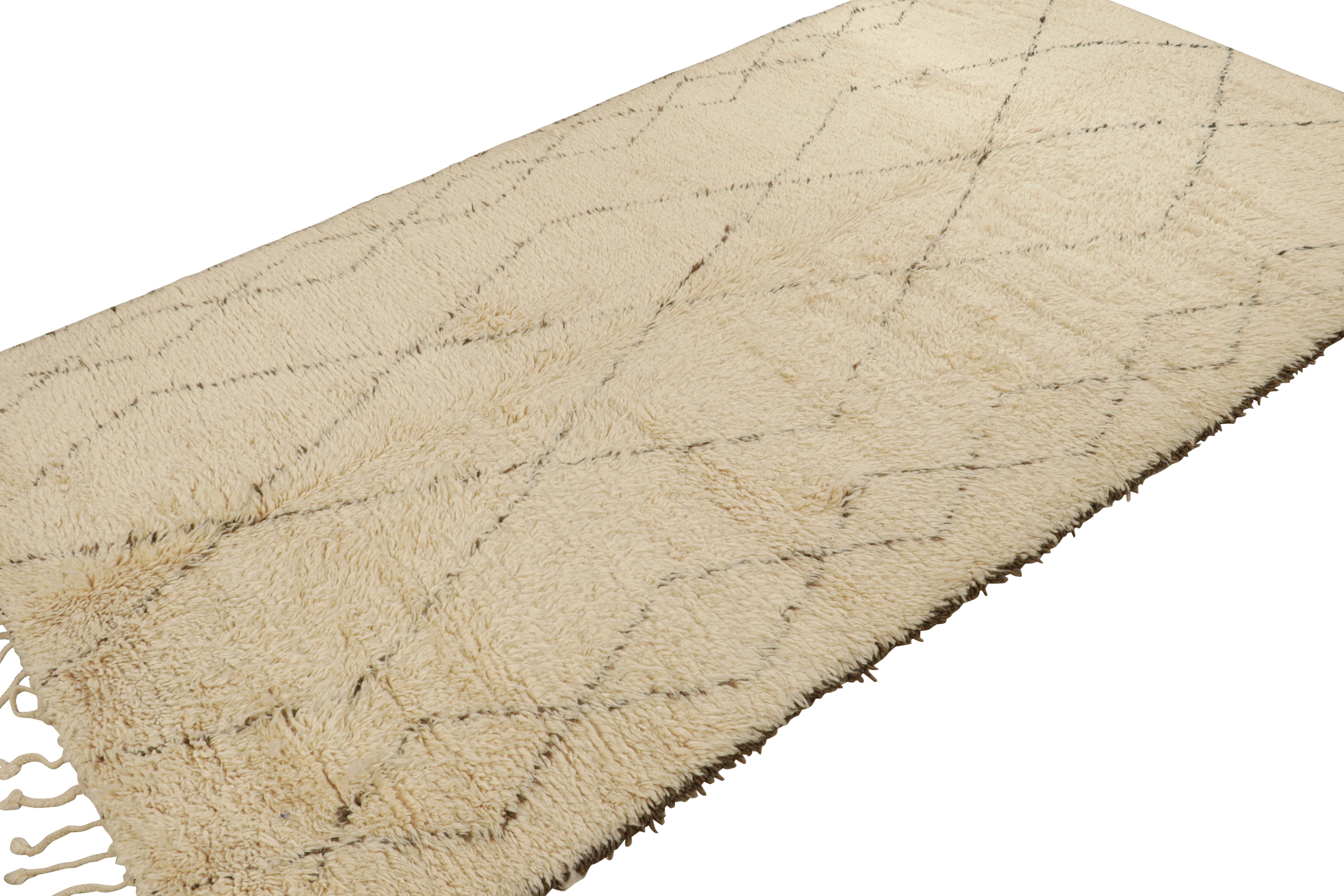 Hand-knotted in wool circa 1950-1960, this 6x11 vintage Moroccan rug is similar to Beni Ourain rugs in its minimalist sensibility. 

On the Design: 

Connoisseurs may admire the subtle appeal of this antique rug that comes from a Berber geometric
