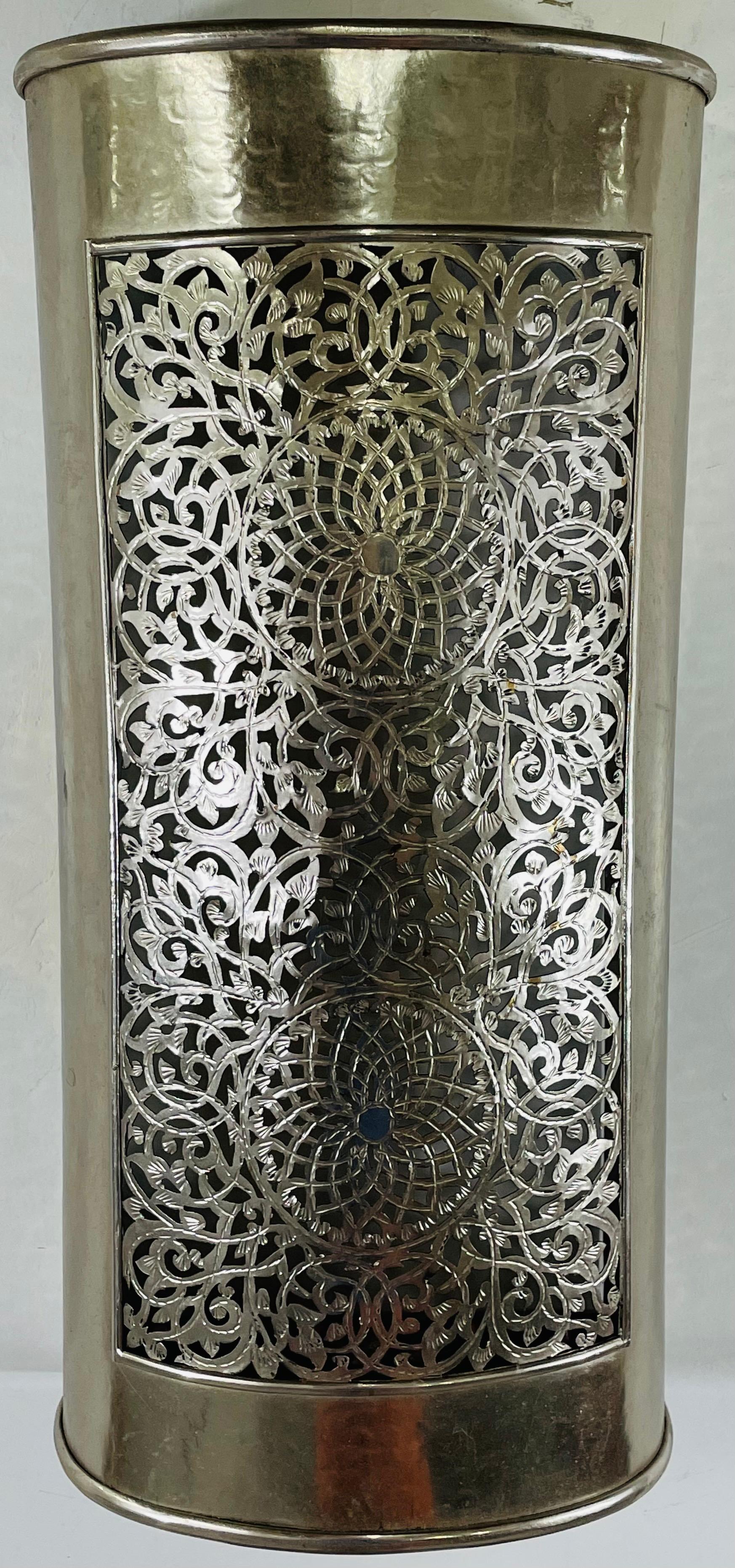 A stunning pair of vintage Moroccan style silver tone wall sconces. The sconces feature a semi cylindrical shape and intricate filigree design creating an exotic vibe and elevating the style of your space. They will look amazing in a bohemian style