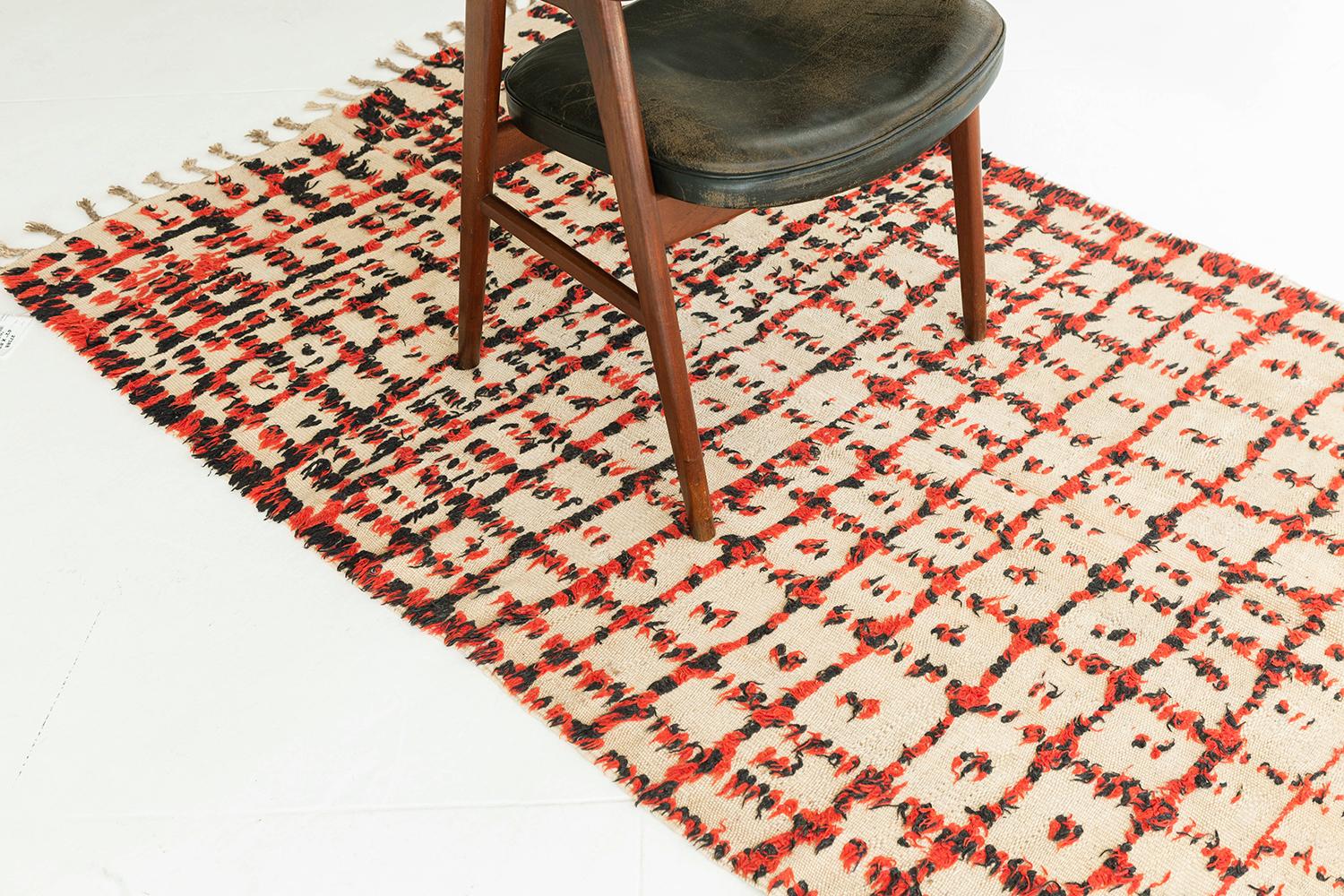 Natural ivory flatweave field with an artfully irregular grid design rendered in eye-catching red and black knots. A unique piece combining graphical and textural interest. A unique vintage tribal rug from the Atlas Mountains of Morocco.

Rug