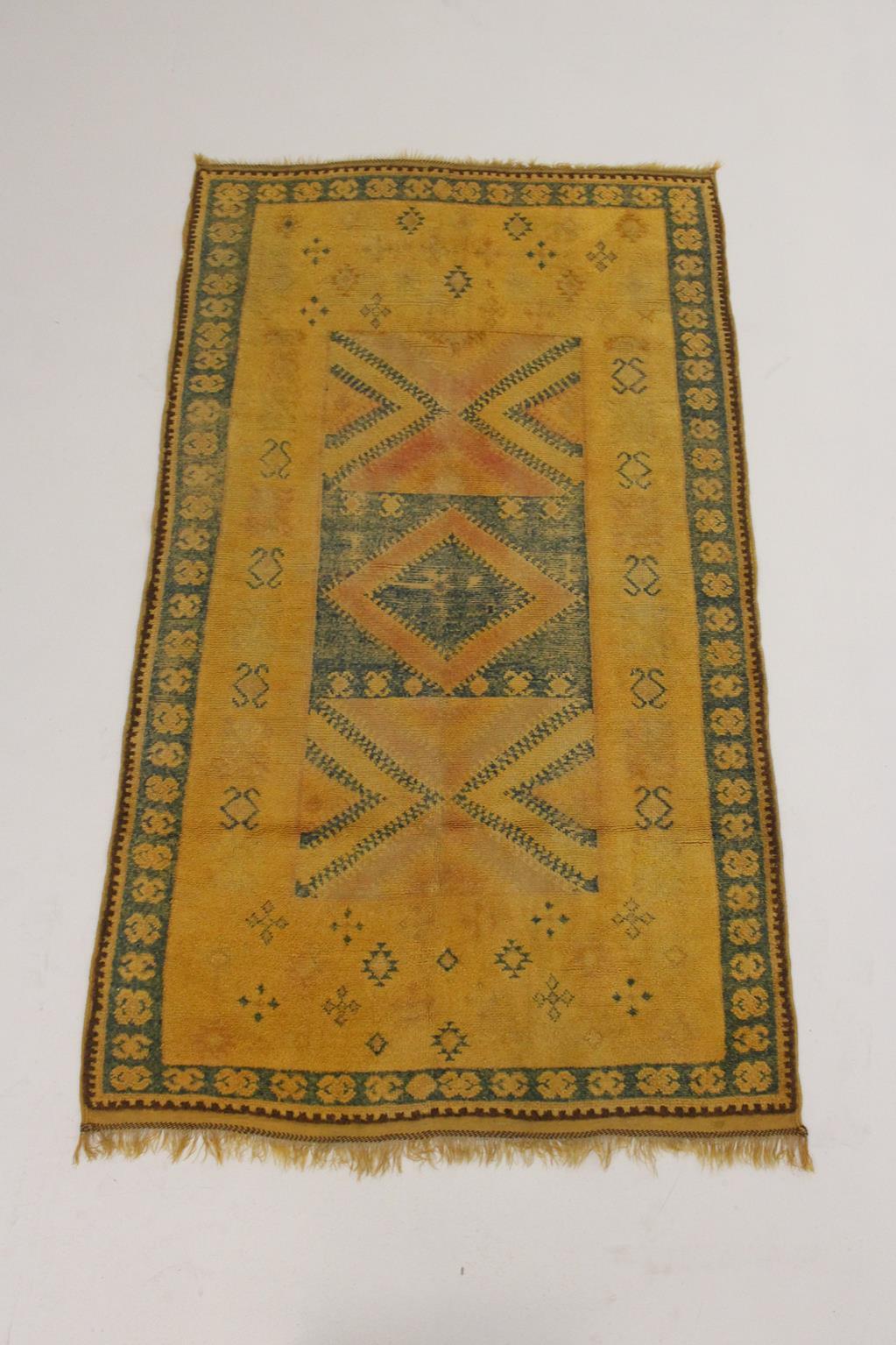 I selected this beautiful rug from piles of carpets because I have always loved a good vintage Taznakht rug with bright, saffron color. Background of this one is a natural dyied yellow with indigo blue and faded red designs (+brown borders). The
