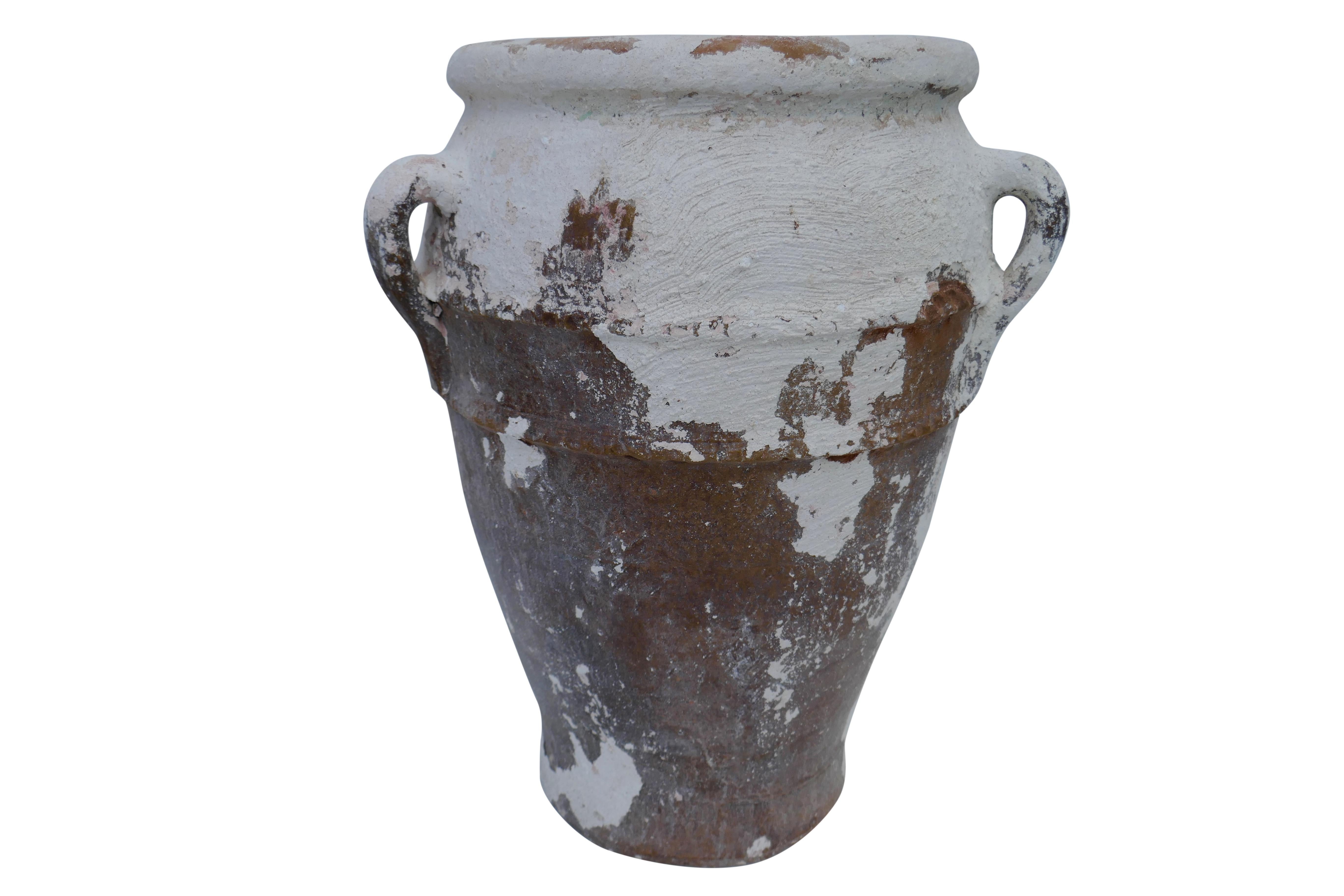 A wonderful original vintage hand-crafted Moroccan terracotta water vessel. This beautiful find displays the natural age, wear and patina that only time can create. Natural occurring distress and chipping of the white water cooling shell layer, 3