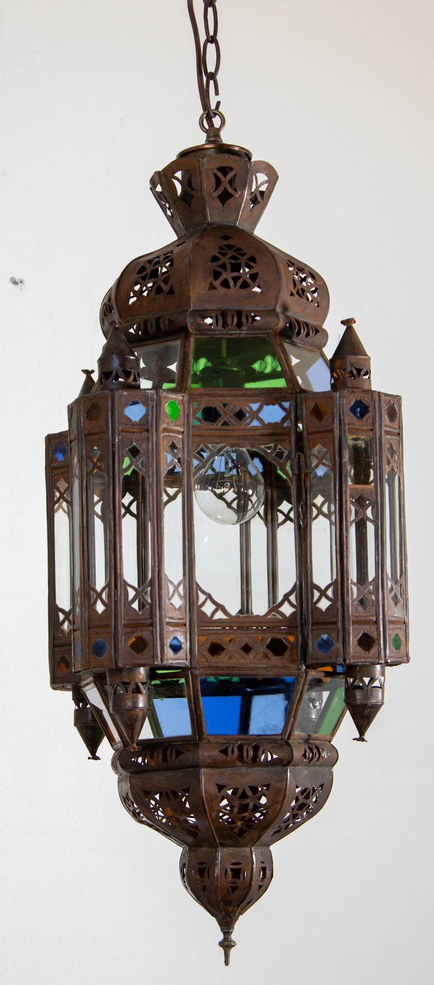 Vintage Moroccan Traditional Moorish clear glass and multicolor lantern.
Large Moroccan patinated metal and glass lantern, ceiling light Moorish pendant lantern.
Multicolor glass, amber, Blue, Green and clear, multifaceted and intricate filigree