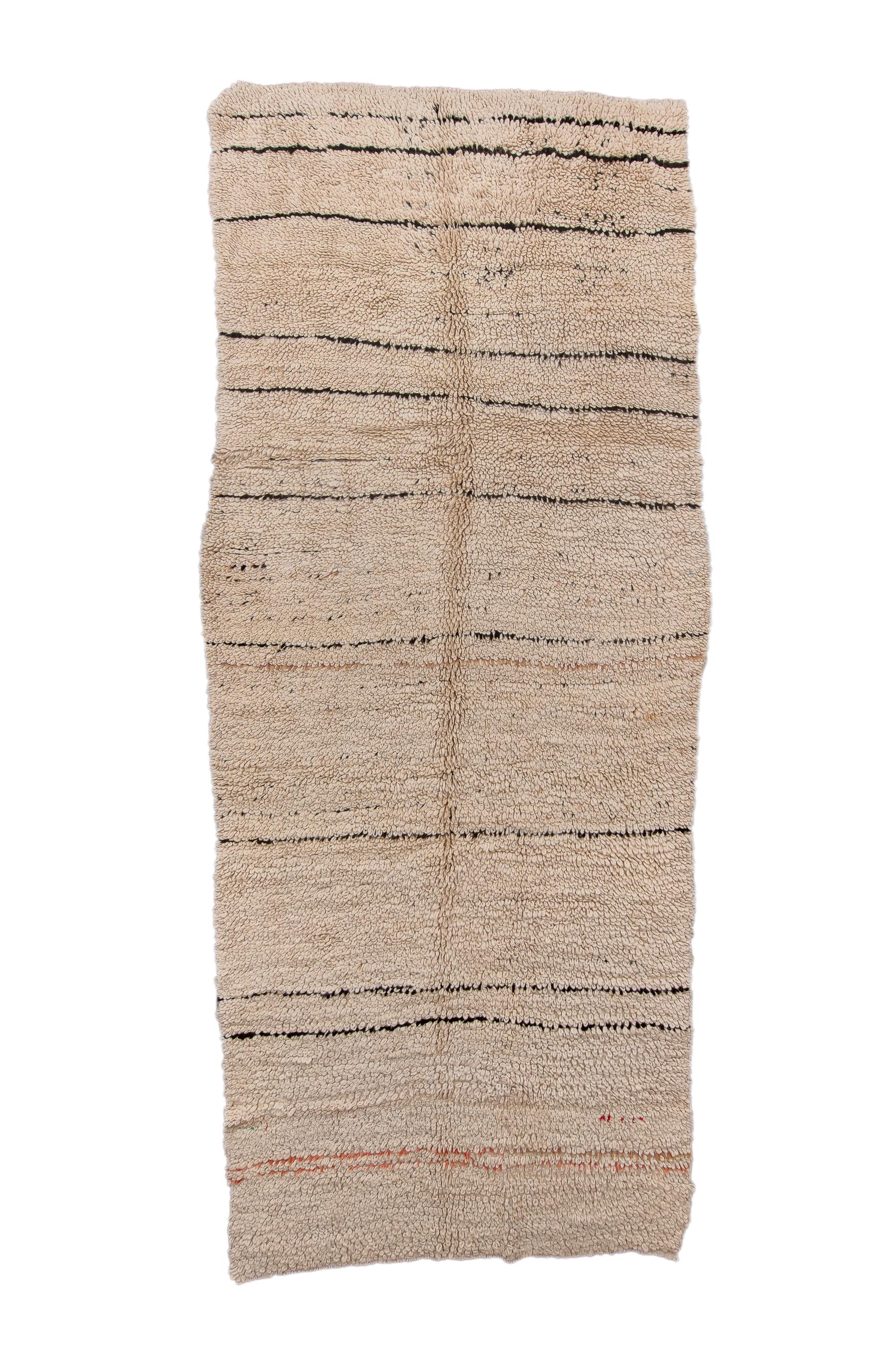 This roughly woven, coarse weave tribal kellegi (long carpet) shows broken, irregularly spaced and drawn brown lines and weak abrashes against the oatmeal ground, in a borderless context. The carpet bens, bows and wriggles to assert its
