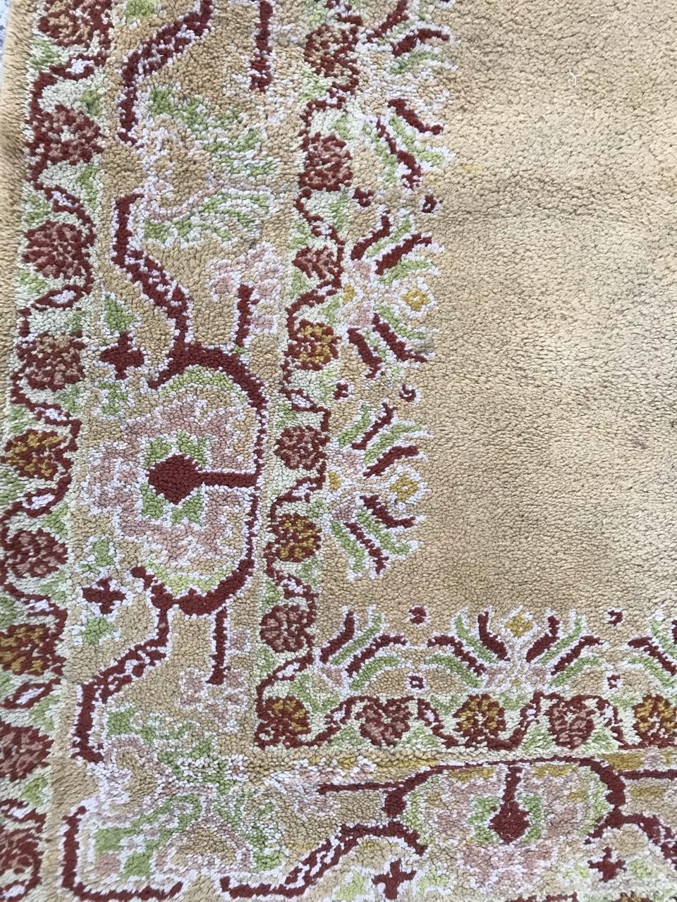 Nice 20th century Moroccan rug with a central medallion design and a yellow field with brown and green, entirely hand knotted with wool velvet on cotton foundation.