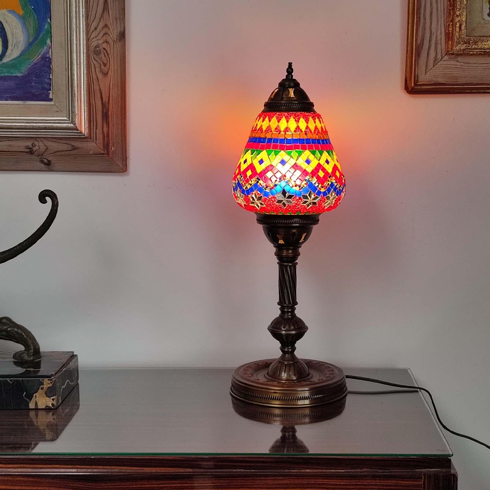 Wonderful vintage Moroccan mosaic table lamp, copper body with a glass shade made of mosaic glass, glass beads and mirror pieces. 1xE27 light bulb. Very good used condition, no damages.

Measurements: 56 cm height, 18,5 cm diameter.