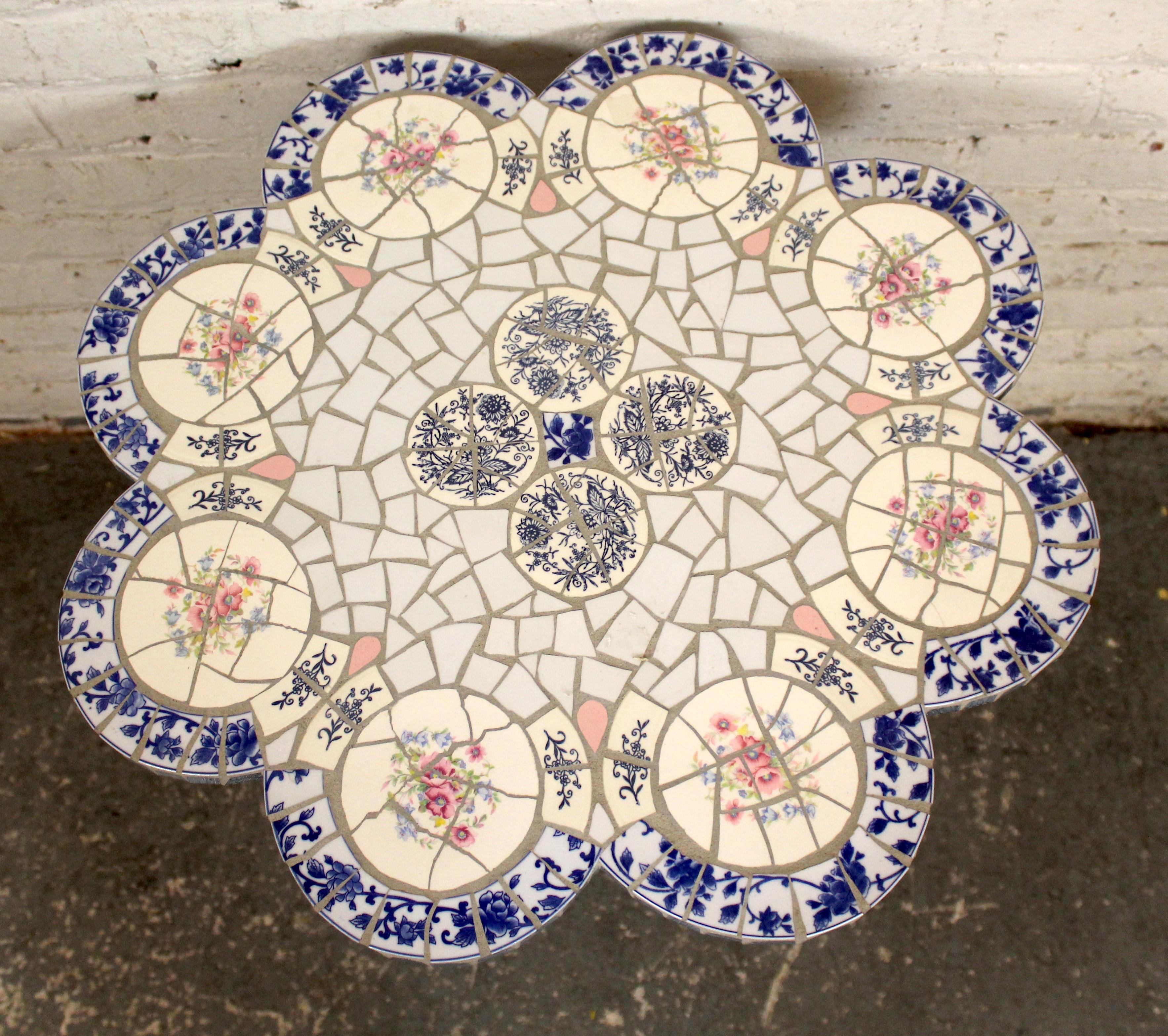 Mid-century modern ceramic mosaic tile table featuring a vibrant hand-laid tile surface with geometric patterns. Supported by a sleek metal base, this vintage piece combines artistry and function, making it a striking accent for indoors or
