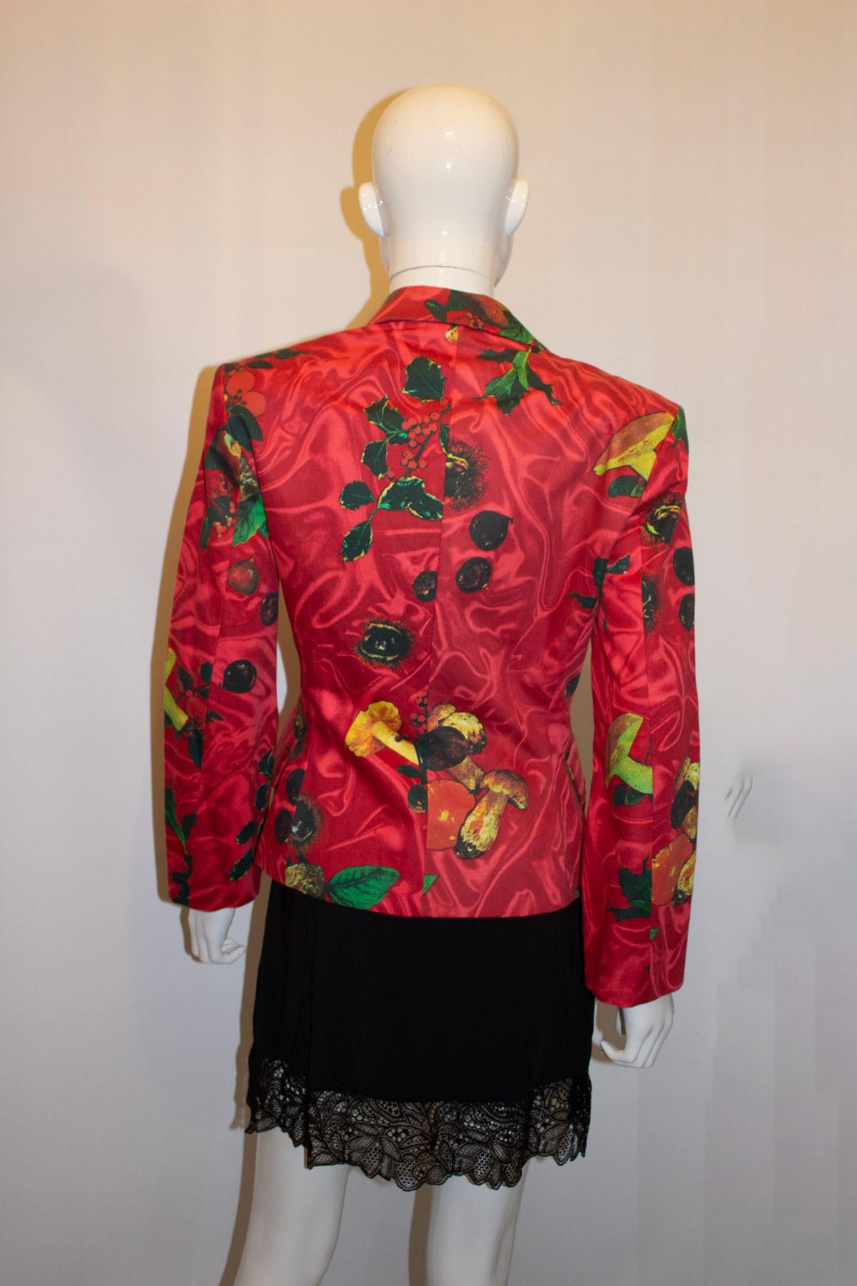 A fun and striking cotton jacket by Moschino. The cotton jacket has a fruit and fauna print on the outside with stipe bow detail, and cut away collar The lining details it as Moschino, Primavera estate Collection 1989, collezione 2. It fastens with