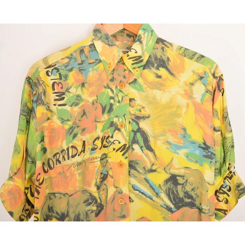 Wonderful Vintage 1990's Moschino short sleeved Blouse in a beautiful yellow ombré colour palette, depicting oil painted artwork with slogan 'Stop the corrida system' in reference to Bull Fighting.

MADE IN ITALY

Features:
Short cuffed