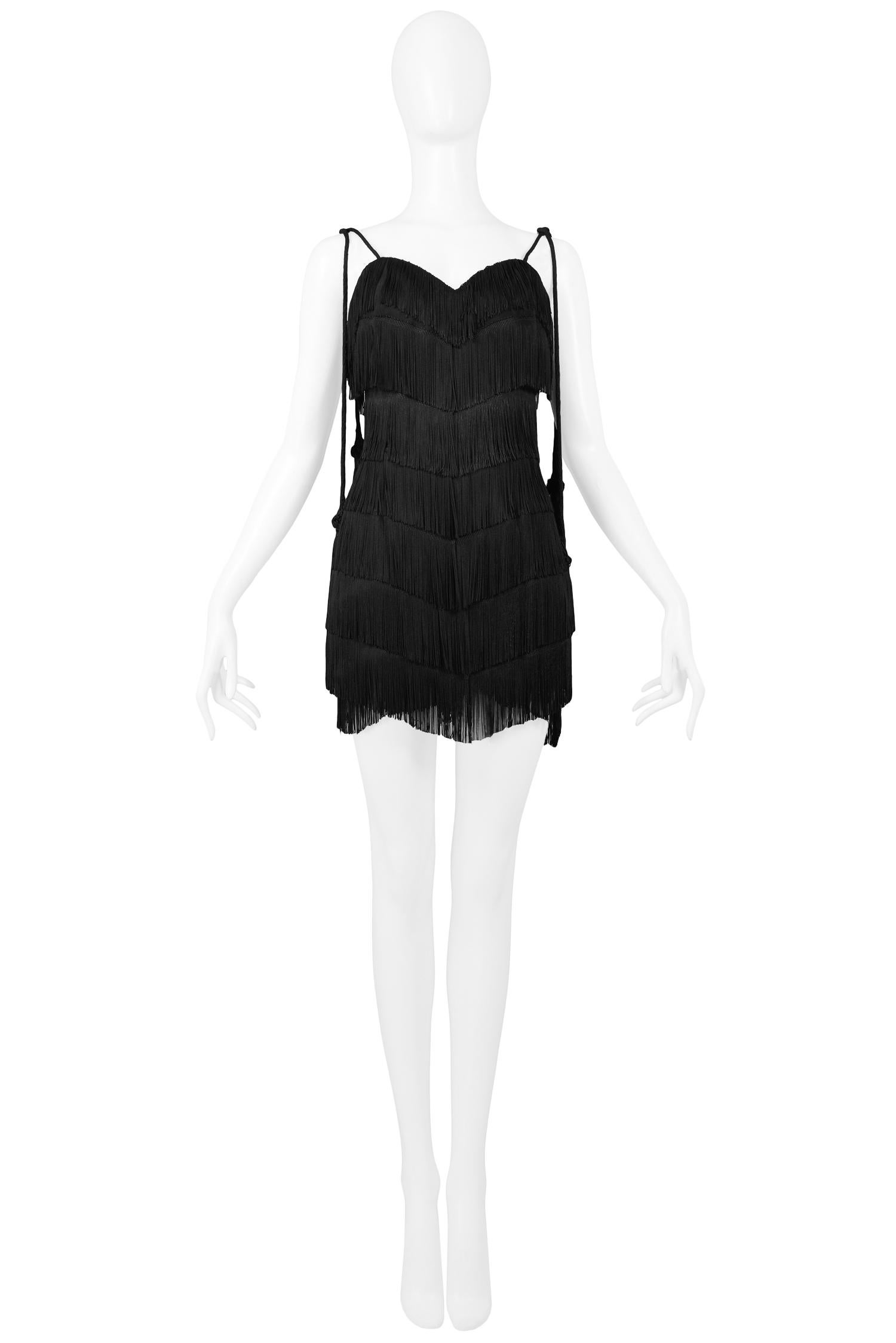 Vintage Moschino black fringed flapper cocktail dress with sweetheart neckline and long tie straps with tassels at the ends. Collection 1990.

Excellent Vintage Condition.

Size 44

Measurements:
Bust 34