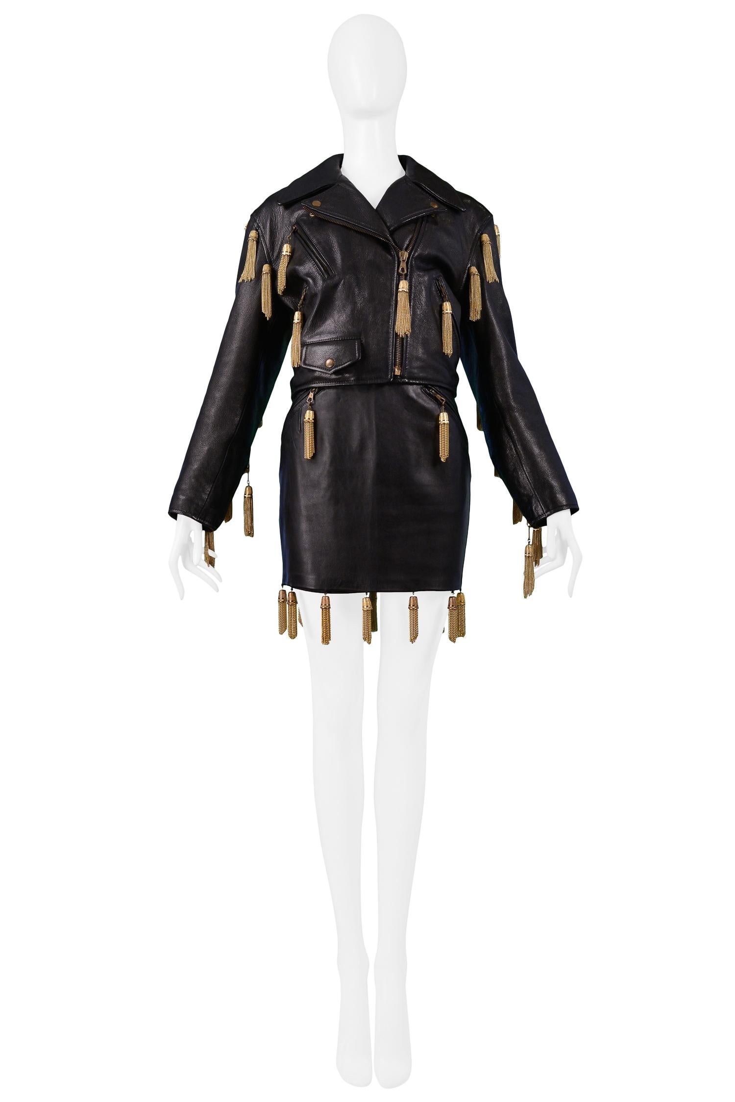 Resurrection Vintage is excited to offer a vintage Moschino by Franco Moschino black leather motorcycle jacket and skirt. Both pieces feature gold thimbles with gold chains. Like new condition. Circa 1989.

Moschino
Size: 42/42
Measurements: Jacket,