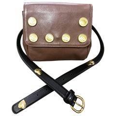 Vintage MOSCHINO brown fanny pack, clutch bag with button motifs and belt.