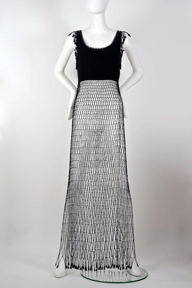 Vintage MOSCHINO CHEAP and CHIC Crochet Beaded Fishnet Mesh Fringe Black Dress

Measurements taken laid flat, please double bust, waist and hips:
Shoulder: 14.17 inches (36 cm)
Bust: 15.74 inches (40 cm) without stretching
Waist: 13.77 inches (35