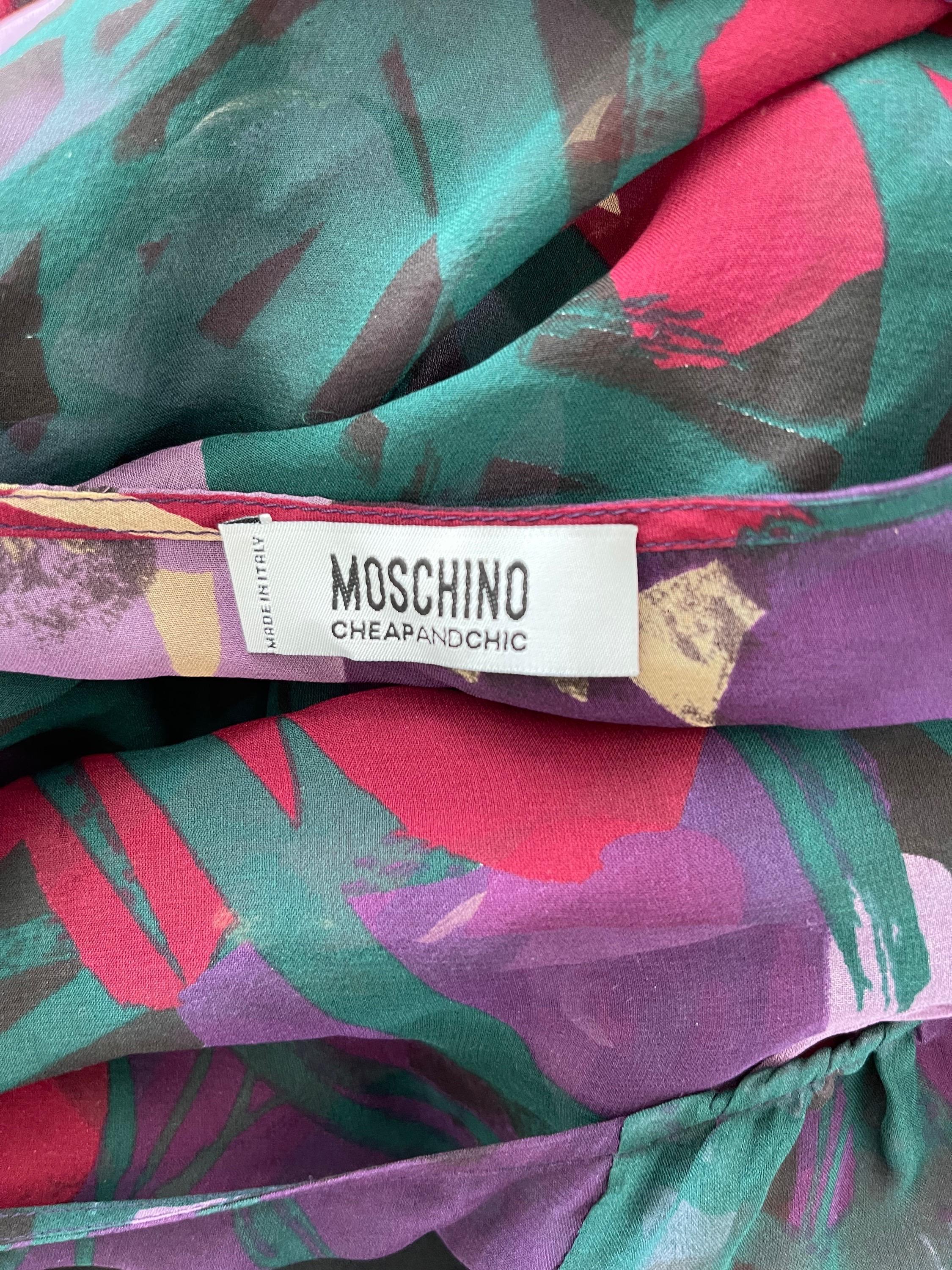 Pretty early 2000s MOSCHINO Cheap & Chic silk chiffon semi sheer wrap blouse and matching silk cami. Vibrant colors of purple, fuchsia, burgundy, green and blue. Attached tie at center waist with buttons up the bust. 
In great condition
Made in