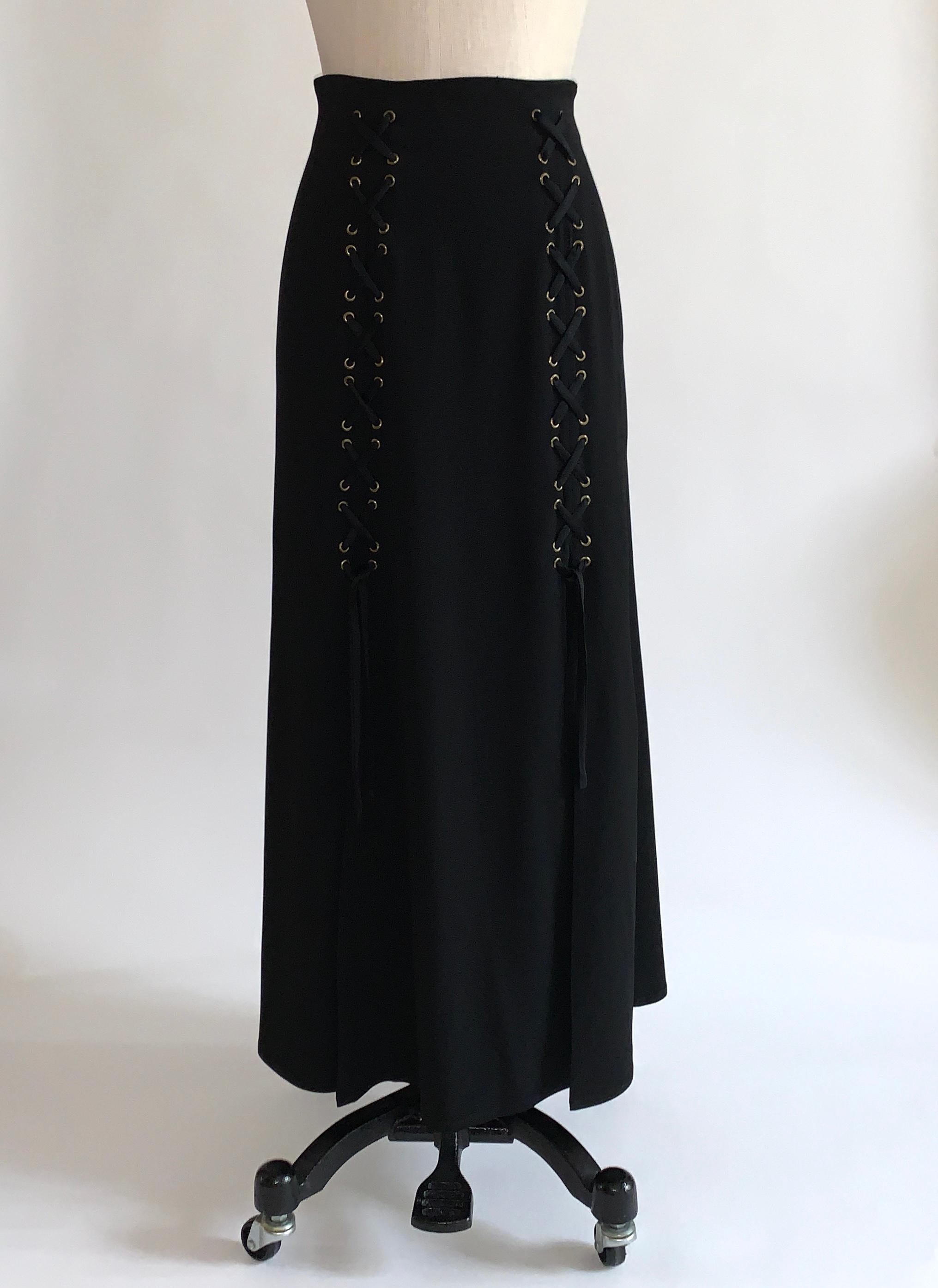 Moschino Cheap & Chic 1990s vintage black maxi length skirt with lace-up/corsetry detail at front. Bronze colored grommets with black lacing. Slits at end of lacing make this breezy and easy to move in! Side zip.

79% acetate, 21% rayon.

Made in