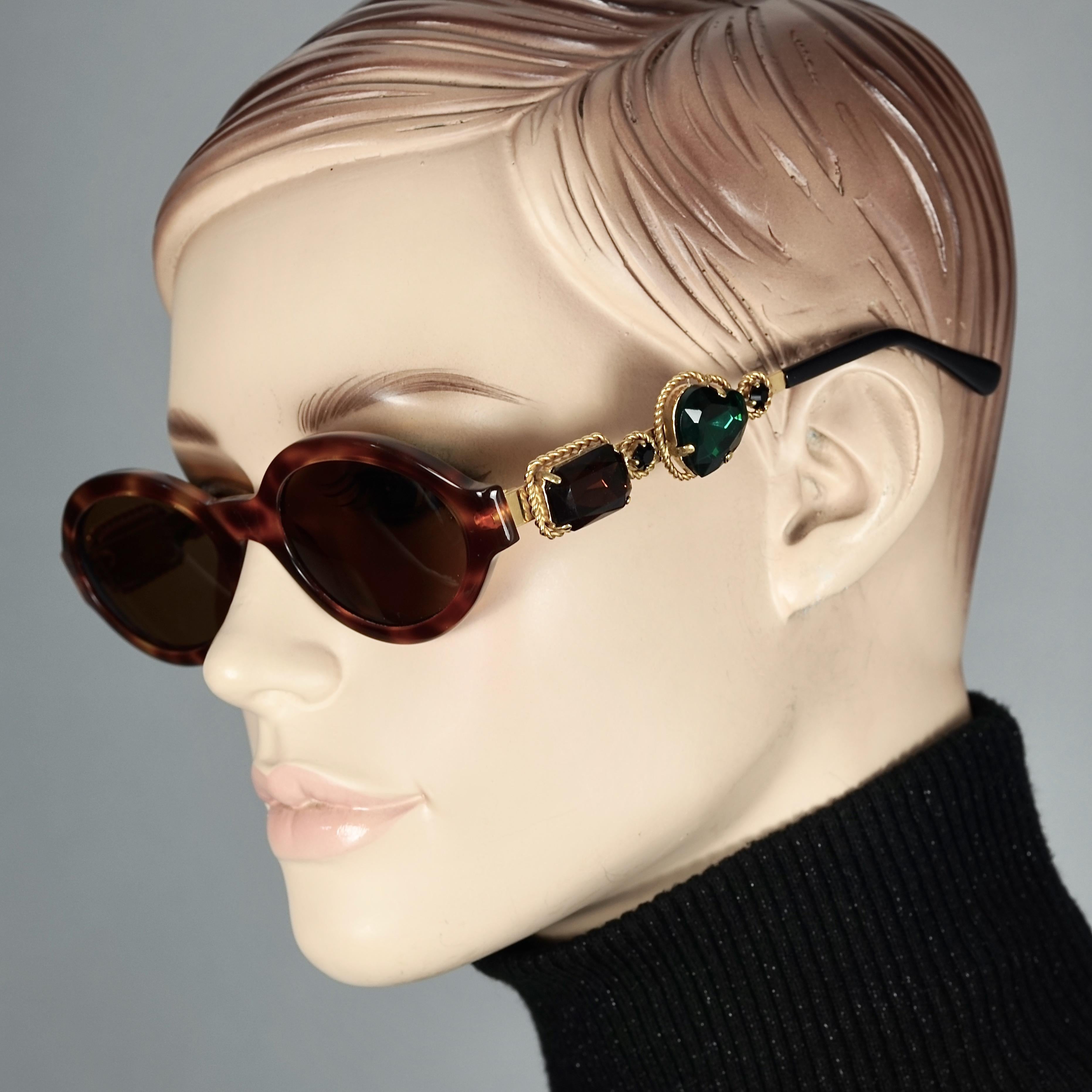 Vintage MOSCHINO Jeweled Tortoiseshell Sunglasses

Measurements:
Height: 1.77 inches (4.5 cm)
Horizontal Width: 5.82 inches  (14.8 cm)
Temples: 5.31 inches  (13.5 cm)

Features:
- 100% Authentic MOSCHINO. 
- Jeweled oval faux tortoiseshell