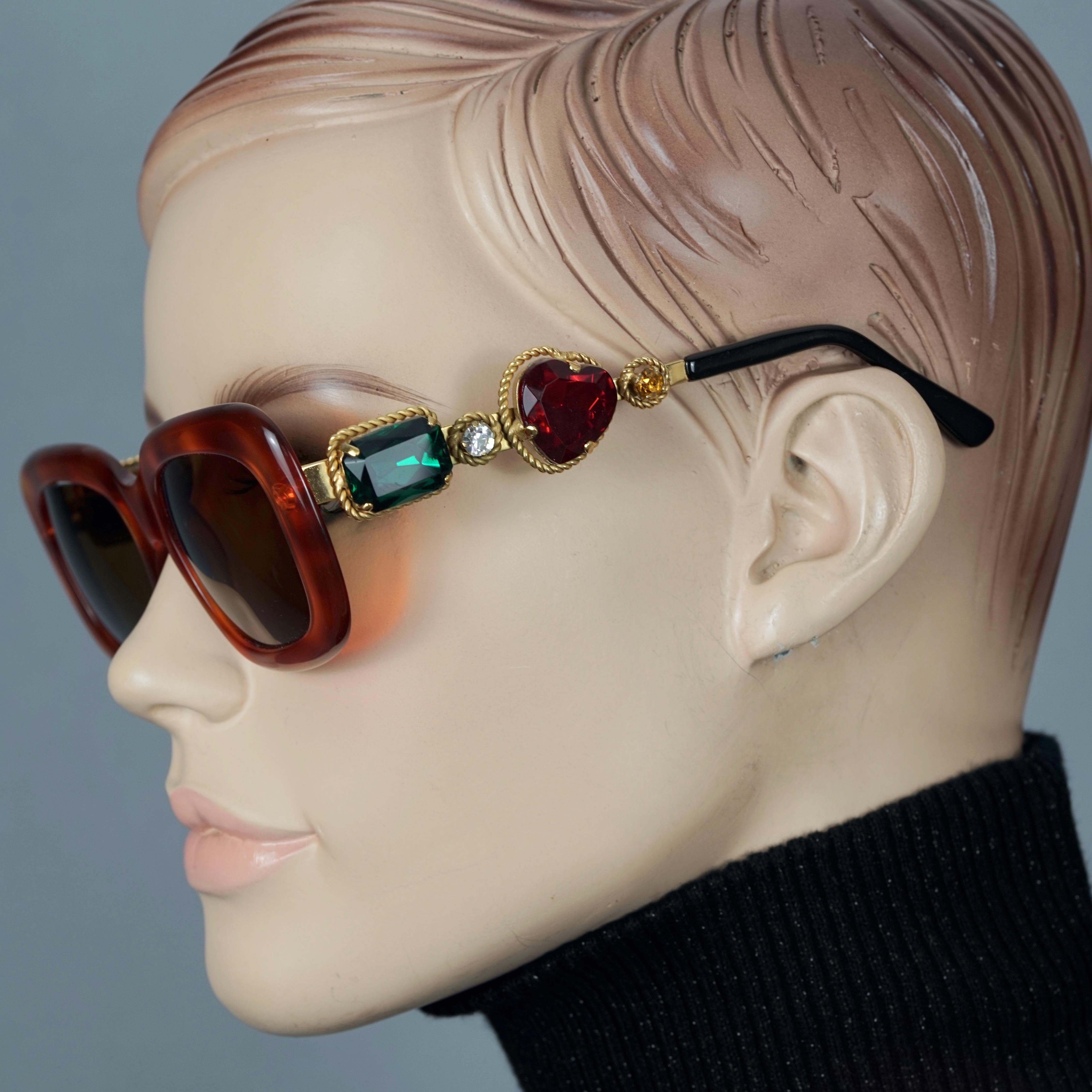 Vintage MOSCHINO Jewelled Tortoiseshell Sunglasses

Measurements:
Height: 1.97 inches (5 cm)
Horizontal Width: 5.75 inches  (14.6 cm)
Temples: 5.12 inches  (13 cm)

Features:
- 100% Authentic MOSCHINO. 
- Jewelled rectangular faux tortoiseshell