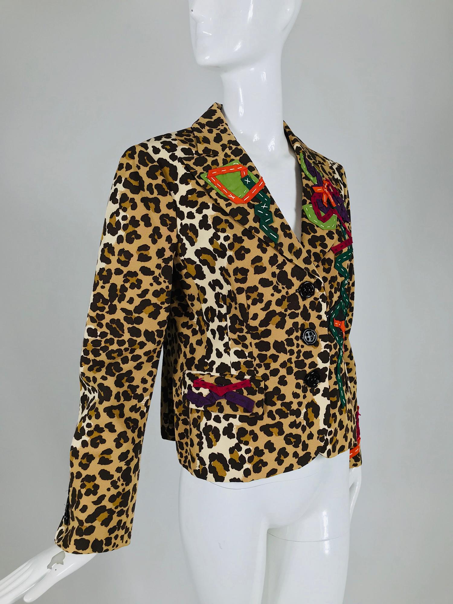 Moschino leopard print faille ribbon applique single breasted jacket. Leopard print faille, single breasted jacket with decorative flap pockets and beautiful coloured ribbon embroidery scattered here and there. Fully lined, closes at the front with