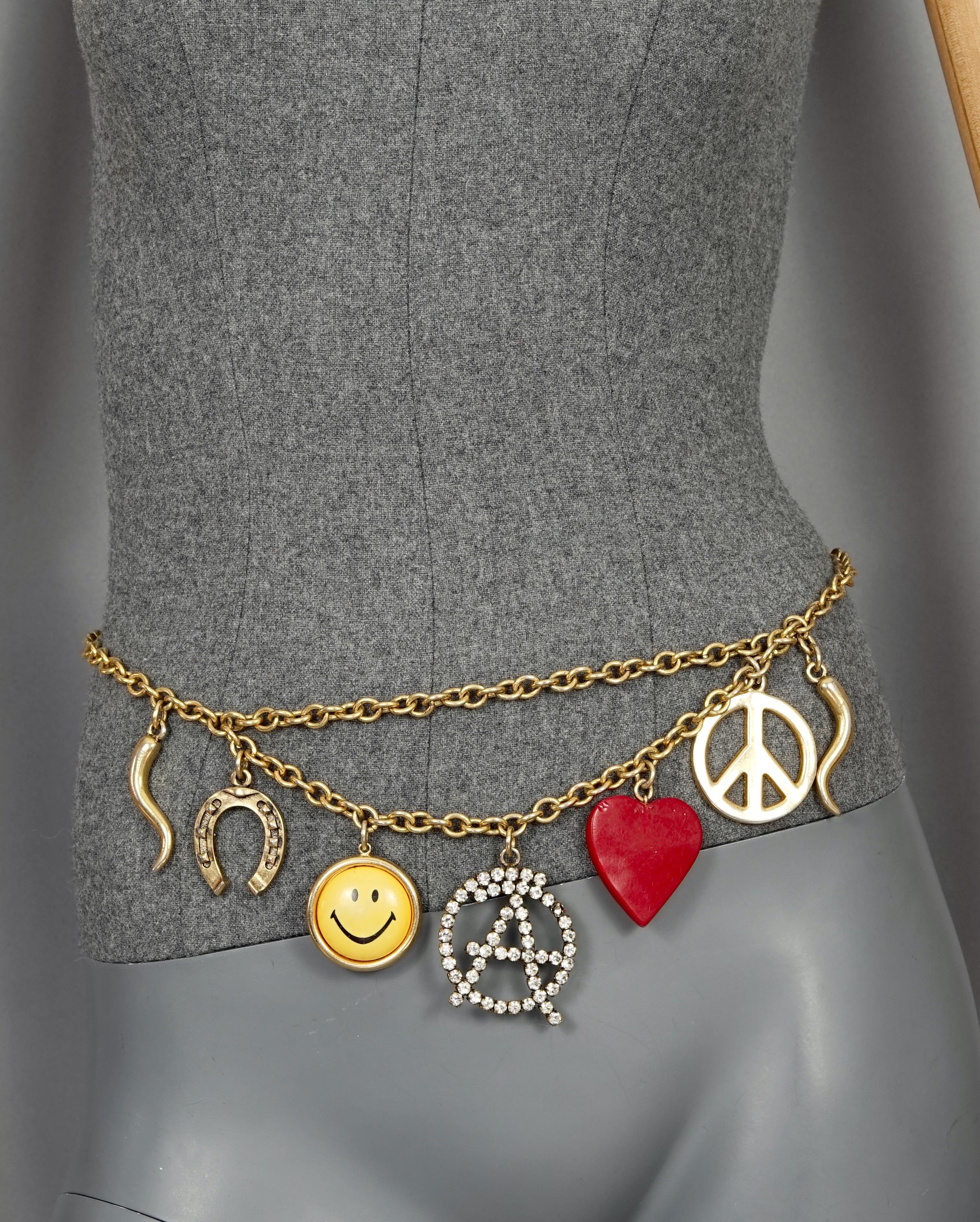 Vintage Iconic MOSCHINO Love Peace Smile Charm Belt

Measurements:
Charms: 3 1/8 inches (biggest)
Length: 46 2/8 inches

Features:
- 100% authentic MOSCHINO.
- Design by Ugo Correani for Moschino.
- Collectable and fun belt/ necklace with charms: