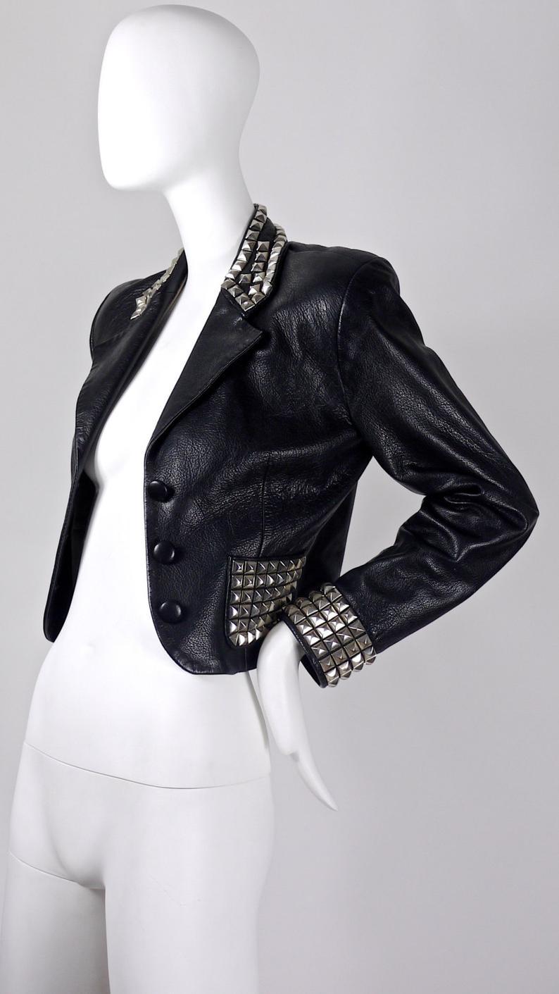 Vintage MOSCHINO Metal Studded Leather Cropped Jacket

Measurements taken laid flat, please double bust and waist:
Shoulder: 16 4/8 inches
Sleeves: 22 4/8 inches
Bust: 18 inches
Waist: 15 inches
Length: 18 4/8 inches 

Features:
- 100% Authentic