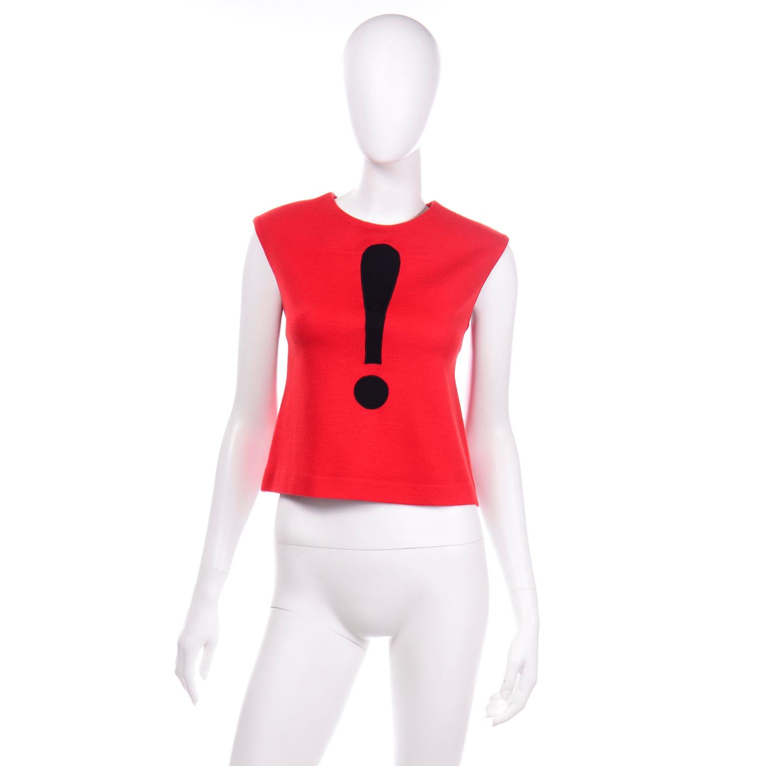 This iconic Cheap and Chic by Moschino red and black exclamation point sleeveless top is a great piece for any collector or Moschino lover. This vintage top has fabric covered buttons down the center back (and has an extra button). It has a round