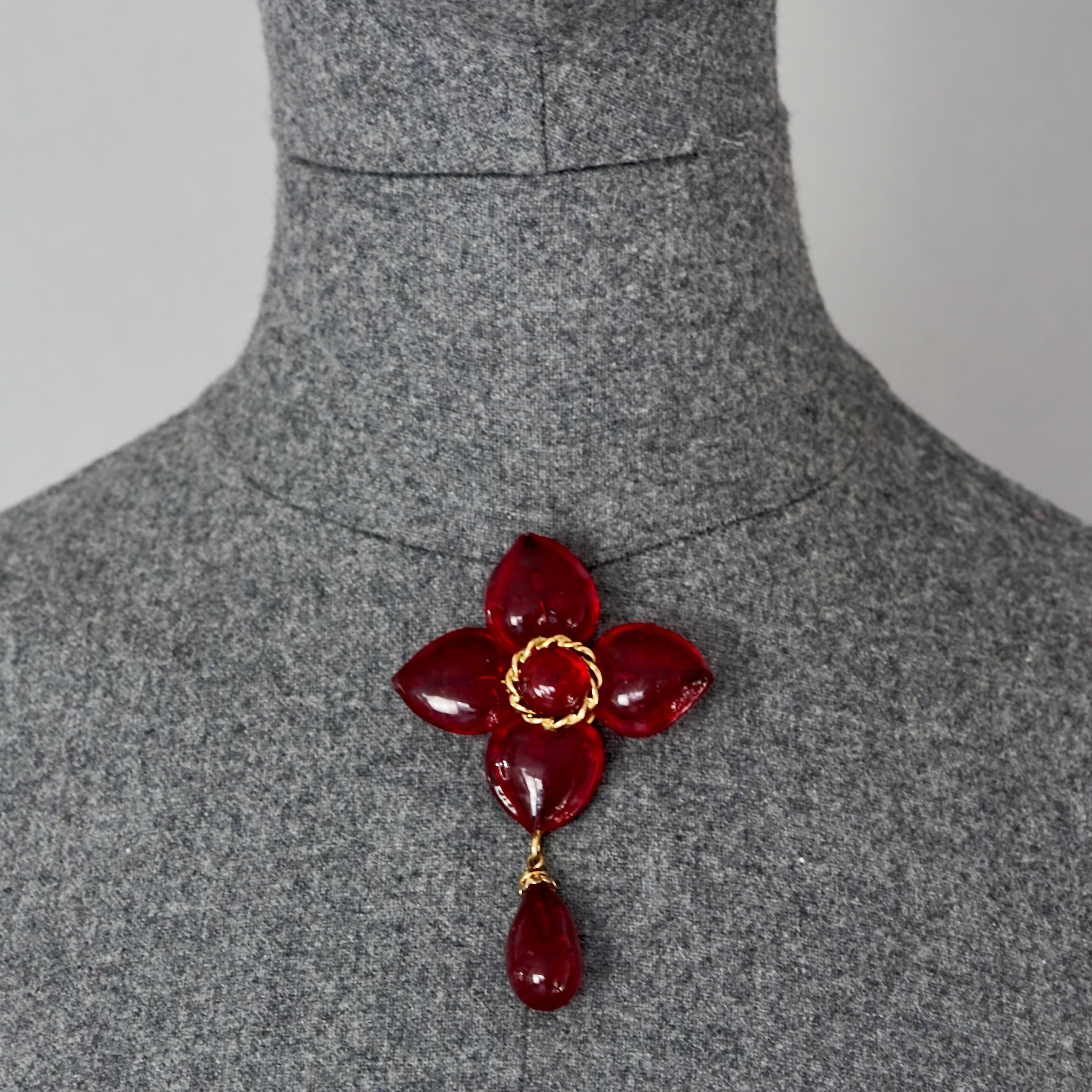 Vintage MOSCHINO Red Heart Flower Novelty Drop Brooch

Measurements: 
Height: 3.54 inches (9 cm)
Width: 2.24 inches (5.7 cm)

Features:
- 100% Authentic MOSCHINO.
- Flower drop brooch in red heart glass cabochons.
- Signed MOSCHINO.
- Gold tone