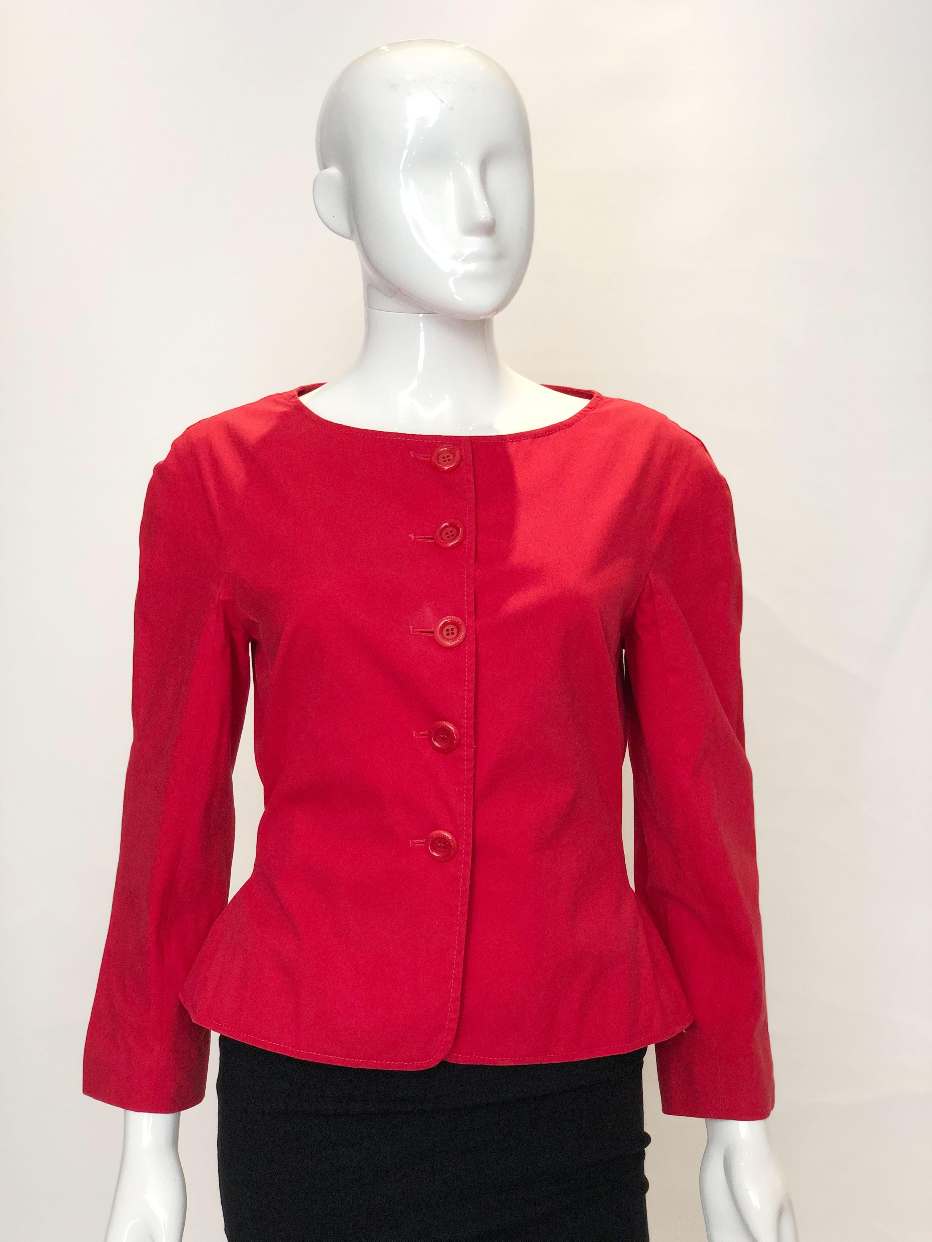 A chich red jacket by Moschino 'cheap and chic' . The jacket has a round neckline, tie back  and is fully lined.