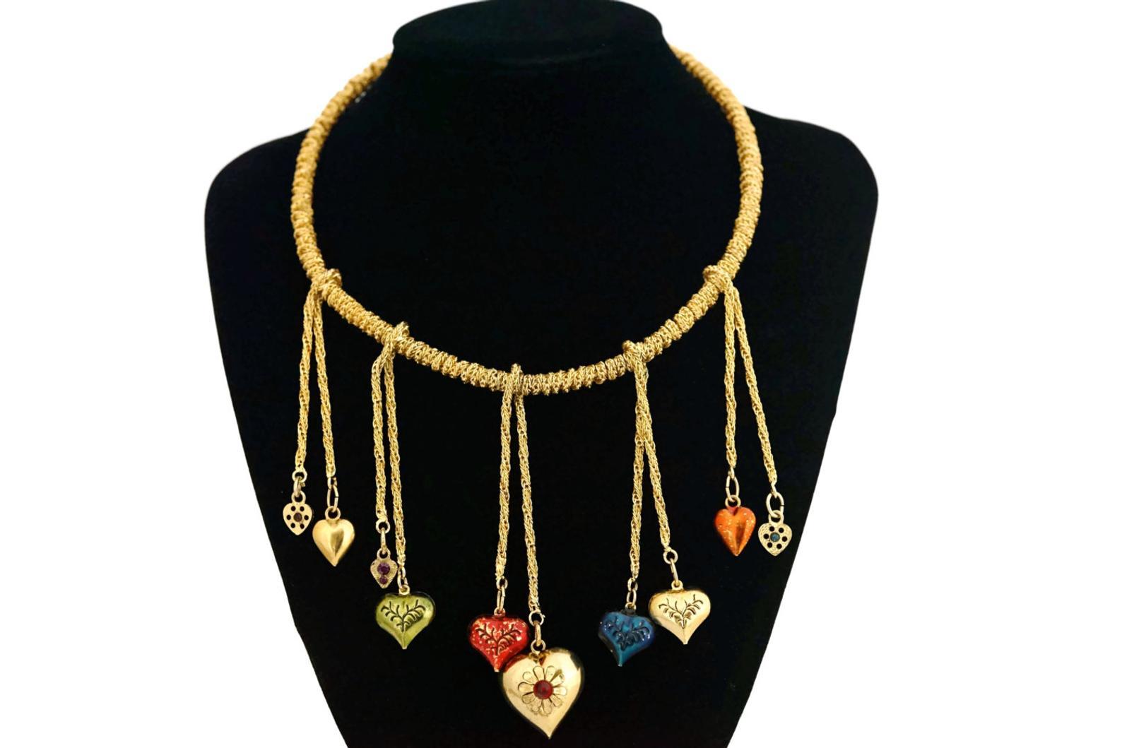 Vintage MOSCHINO Rigid Chain Wrap Fringe Heart Charm Choker Necklace

Measurements:
Height: 4 1/8 inches (longest charm at the centre)
Circumference: 17 inches

Features:
- 100% Authentic MOSCHINO.
- Chains coiled on a rigid choker.
- 10 dangling