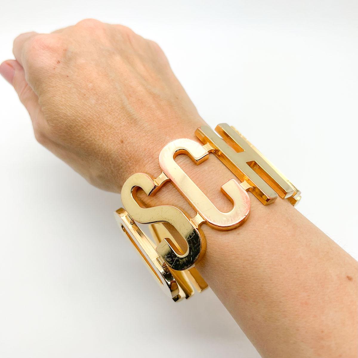 A rare Vintage MOSCHINO Letter Cuff. A large and impressive logo lovers find; this cuff leaves no doubt as to its origin. The ultimate in runway edge this one will prove the logo lovers dream on every outing.
Moschino: Founded in 1983 by Franco