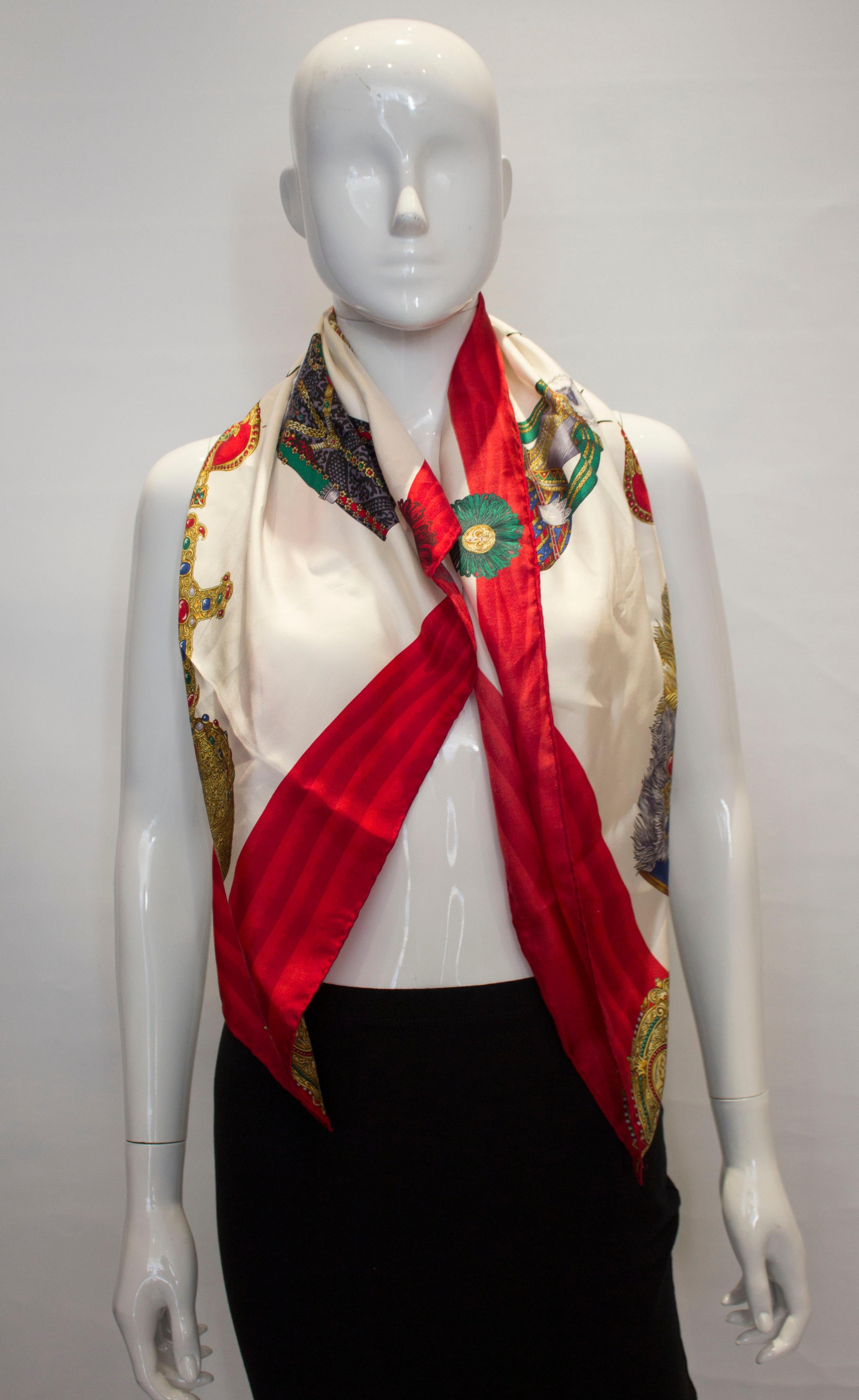 A great gift for Chrsitmas. a vintage hand rolled scarf by Moschino. The scarf has a red border and white centre with crown desgin.
