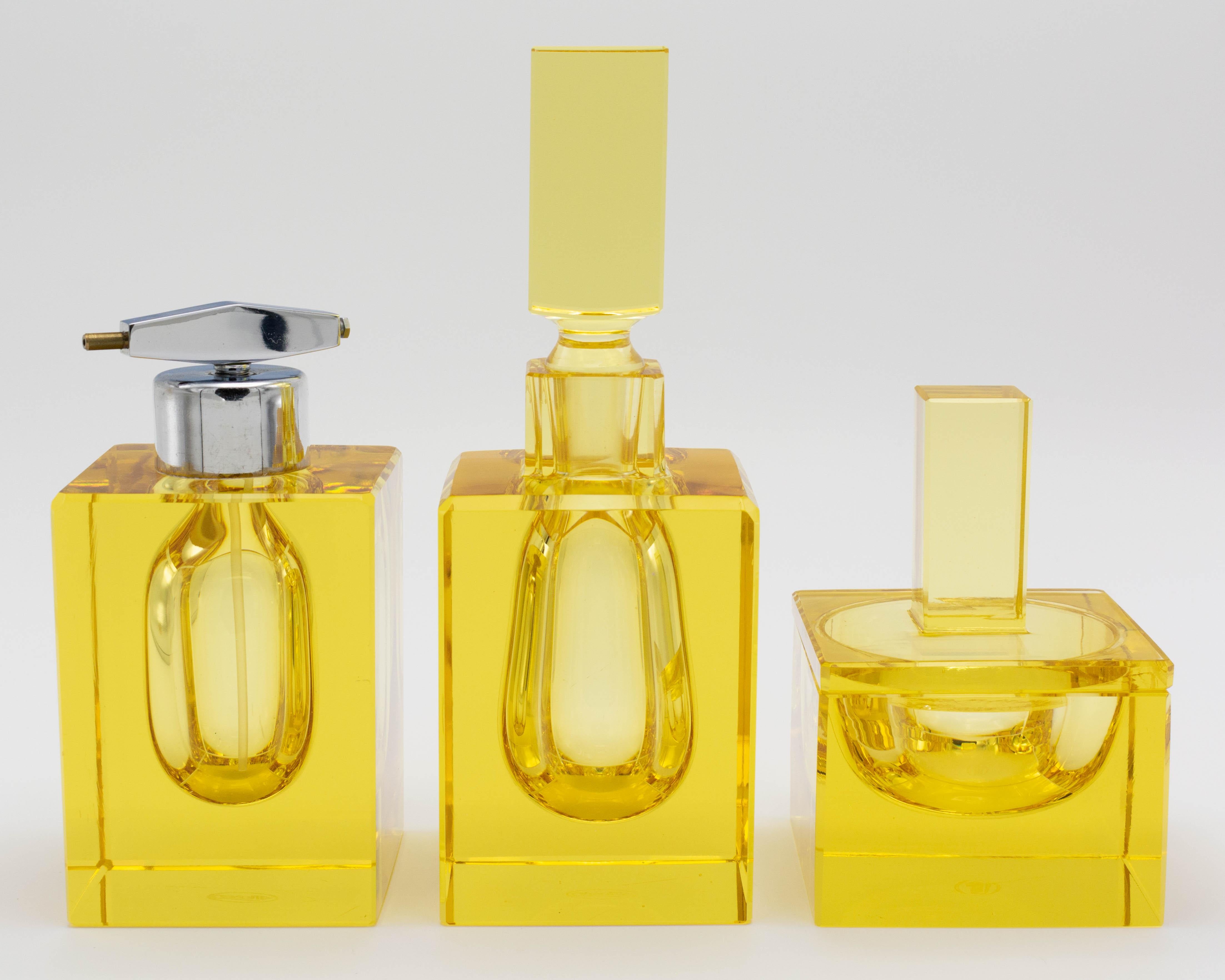An Art Deco style Moser 3 piece cut citrine glass perfume vanity set comprised of a large bottle with stopper, a medium size perfume with chrome atomizer (missing bulb) and a small jar with lid. Excellent quality and condition with bright color. One