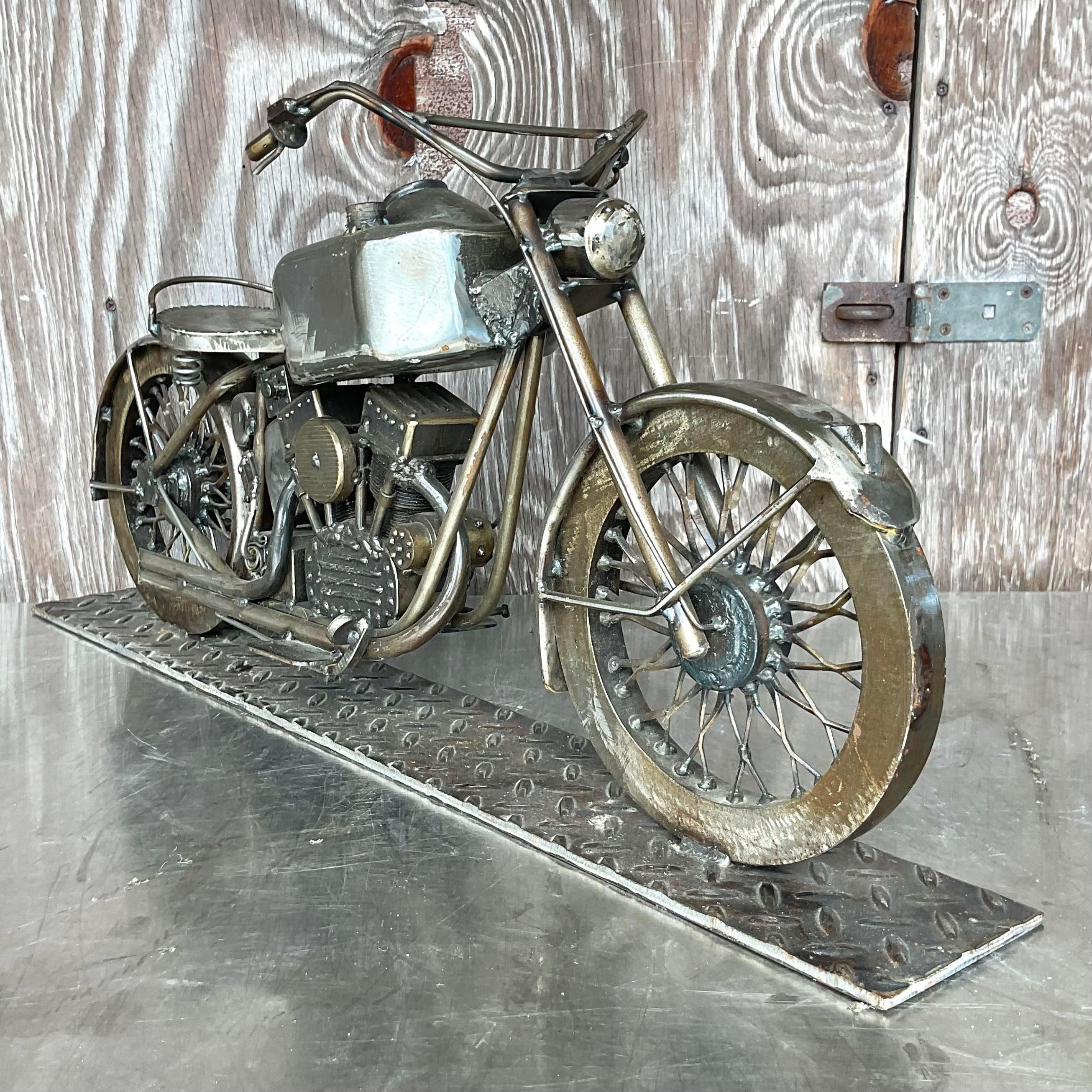 A fabulous vintage Boho motorcycle sculpture. A chic hand crafted brushed stainless steel with incredible attention to detail. Signed on the license plate. Large and impressive. Acquired from a palm Beach estate.