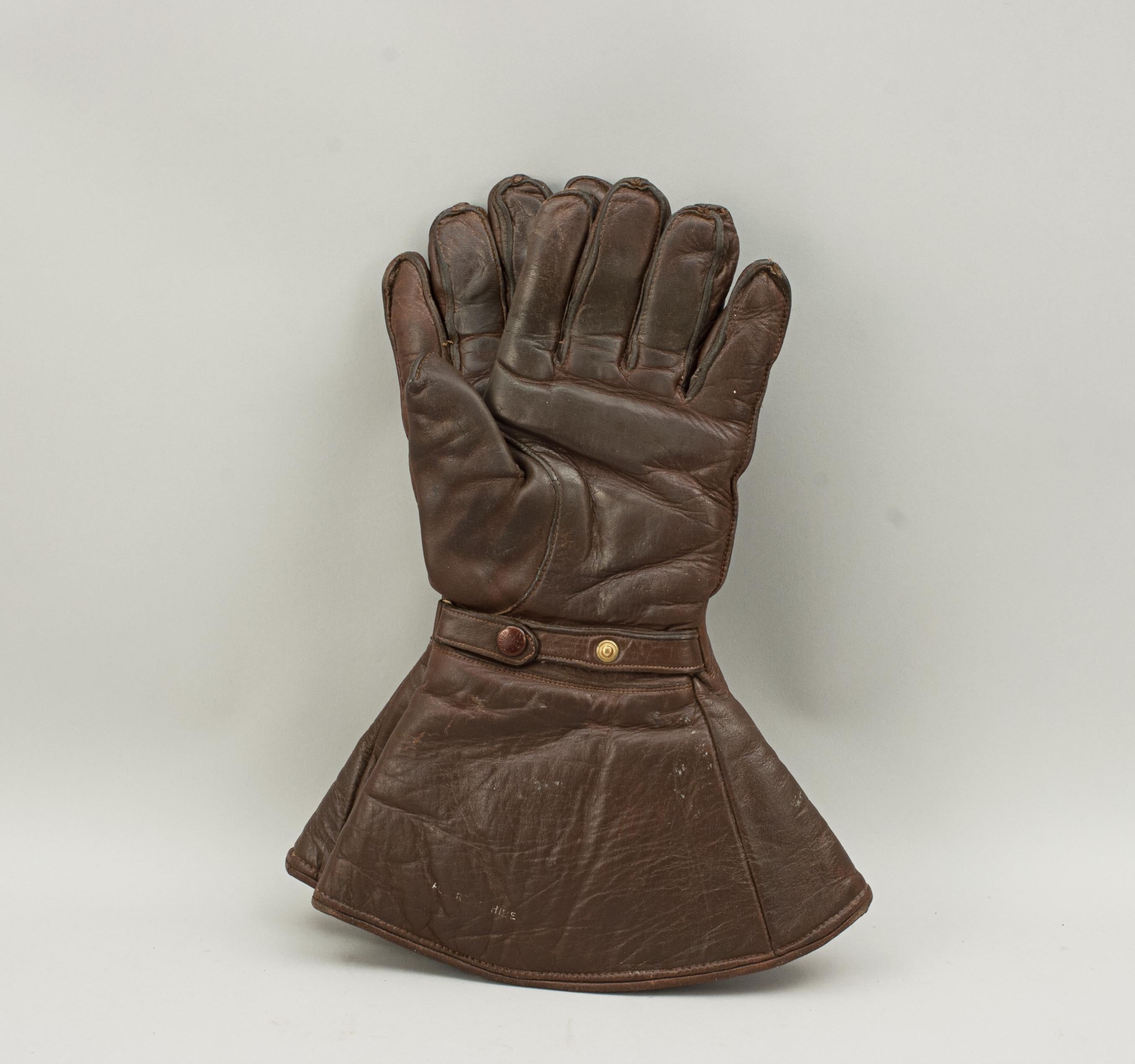 Vintage leather motoring gloves, gauntlets.
A nice pair of leather motoring gauntlets by Hutchinson, London. The brown leather gloves are wool lined and made in England. They are usable gloves for a small to medium hand with an adjustable leather