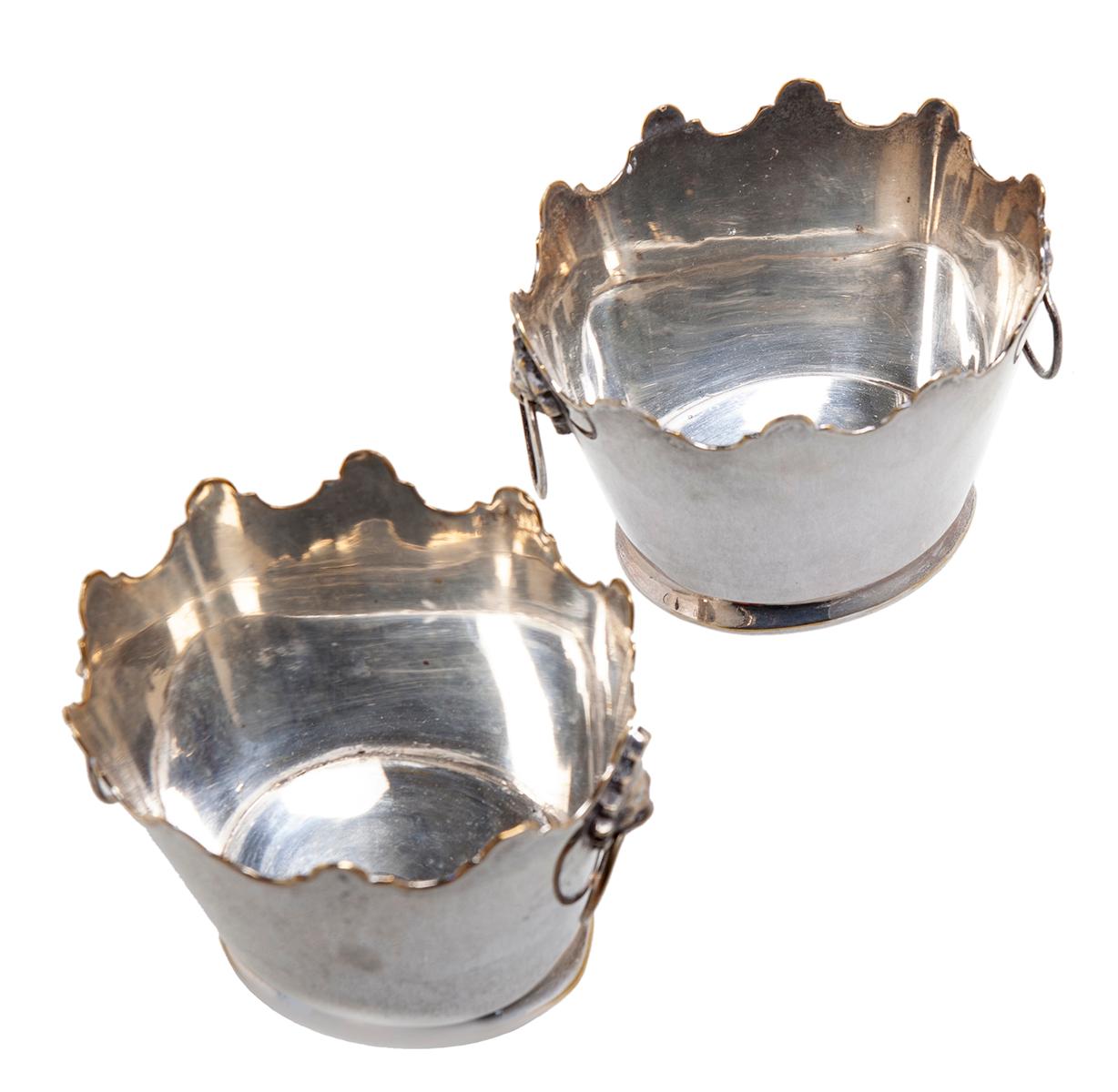A rare pair of Mottahedeh silver plated miniature cachepots with lions & ring handles. 
These charming pieces can be used as personal ice buckets. Heavier than they look & completely water tight. They would be excellent for a variety of uses