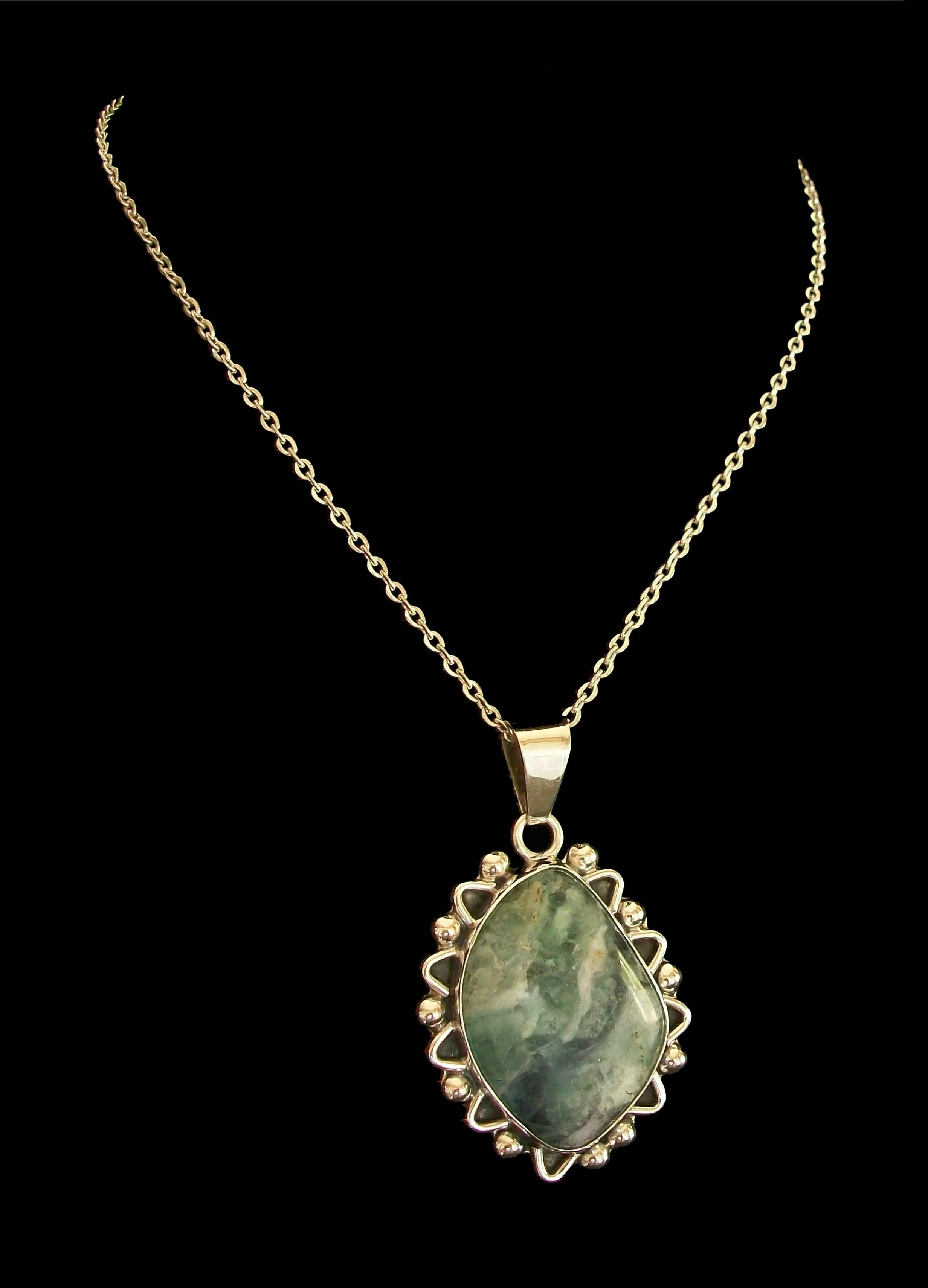 Vintage mottled green Jadeite and fine silver (950/1000) pendant and cable link necklace (unknown metal content) - featuring a large bezel set piece of polished Jadeite of irregular shape (approximately 1
