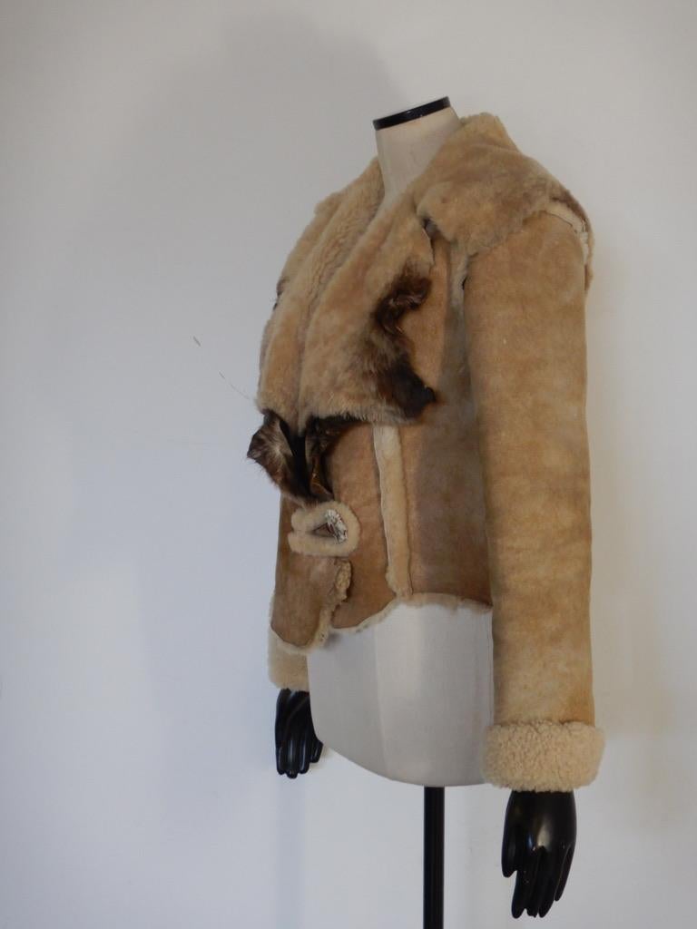 Incredible hand-crafted shearling jacket from Mountain Rhythm. Antler button closure.

The jacket has no size marking.

The jacket is in very good vintage condition. There are no holes or tears in the shearling, no dryness or cracking. There are no
