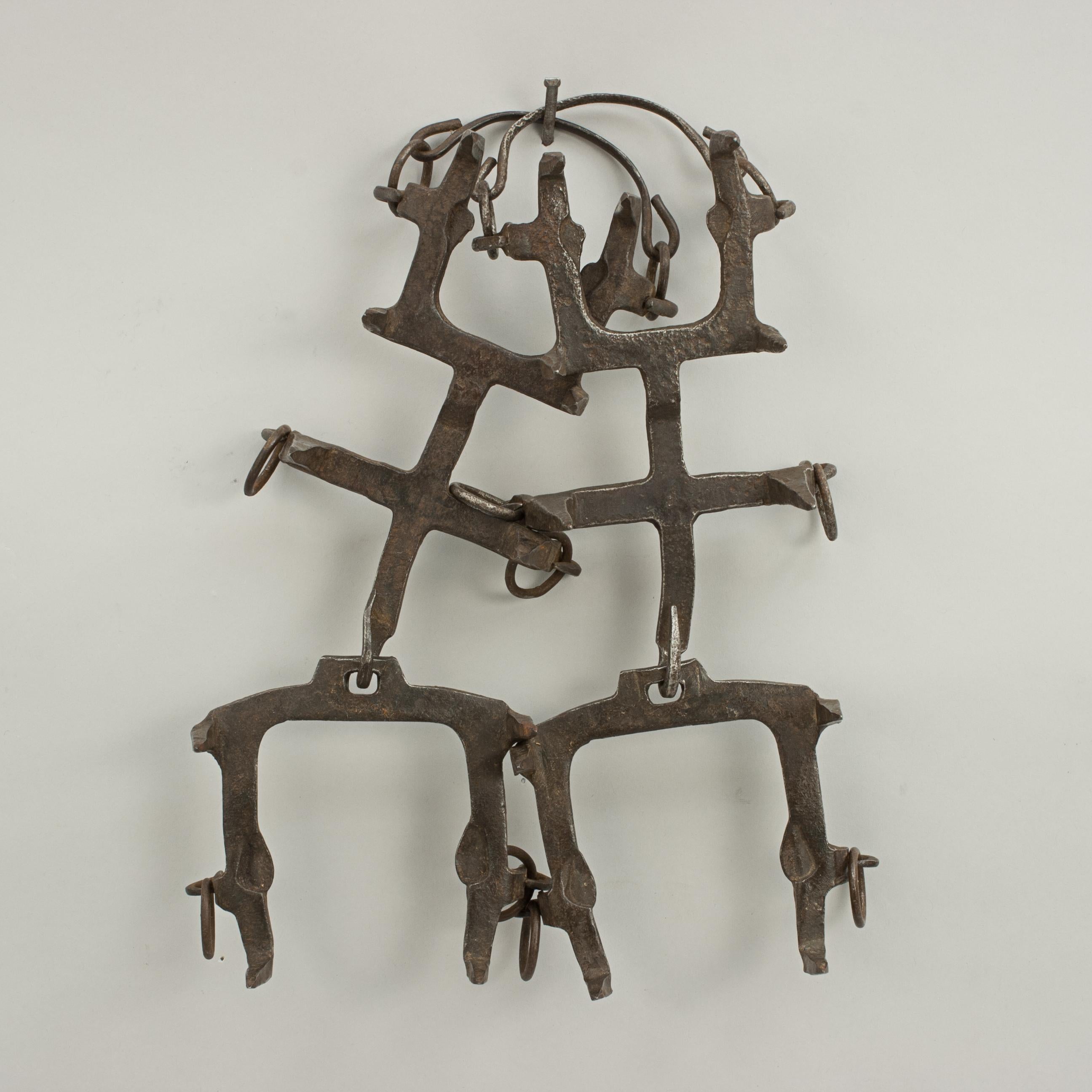 Vintage Mountaineering Crampons.
A pair of early 10 point wrought iron crampons in the design of Oscar Eckenstein (1859-1921). Eckenstein was a passionate climber and innovator. He developed this type of hinged crampons in 1908 and two years later,