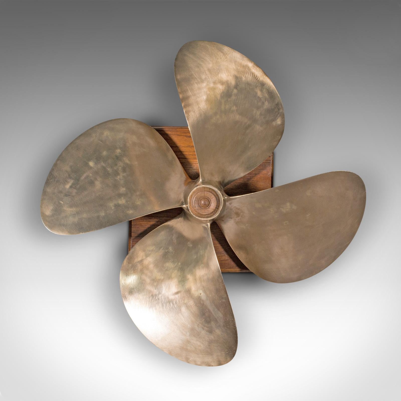 This is a large vintage mounted ship propeller. An English, bronze decorative four-blade maritime prop, dating to the mid 20th century, circa 1950.

Wonderfully presented propeller of superb proportion
Displays a desirable aged patina and in good