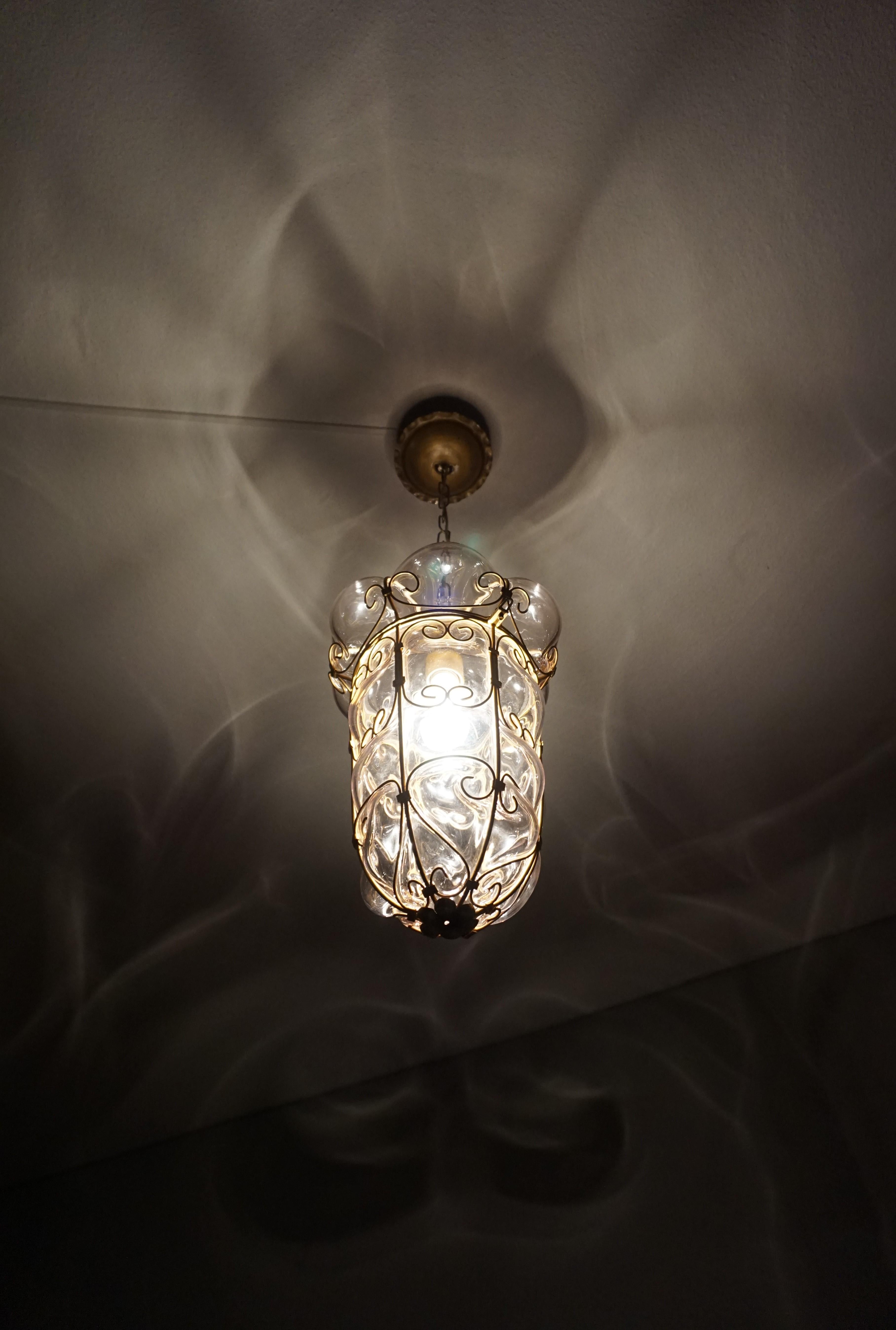 Marvelous shape, 1950s Venetian pendant with the original maker's mark.

This midcentury made, Italian light fixture is an absolute joy to look at, both on and off. With the light switched off, it is an Italian work of glass art on your ceiling and
