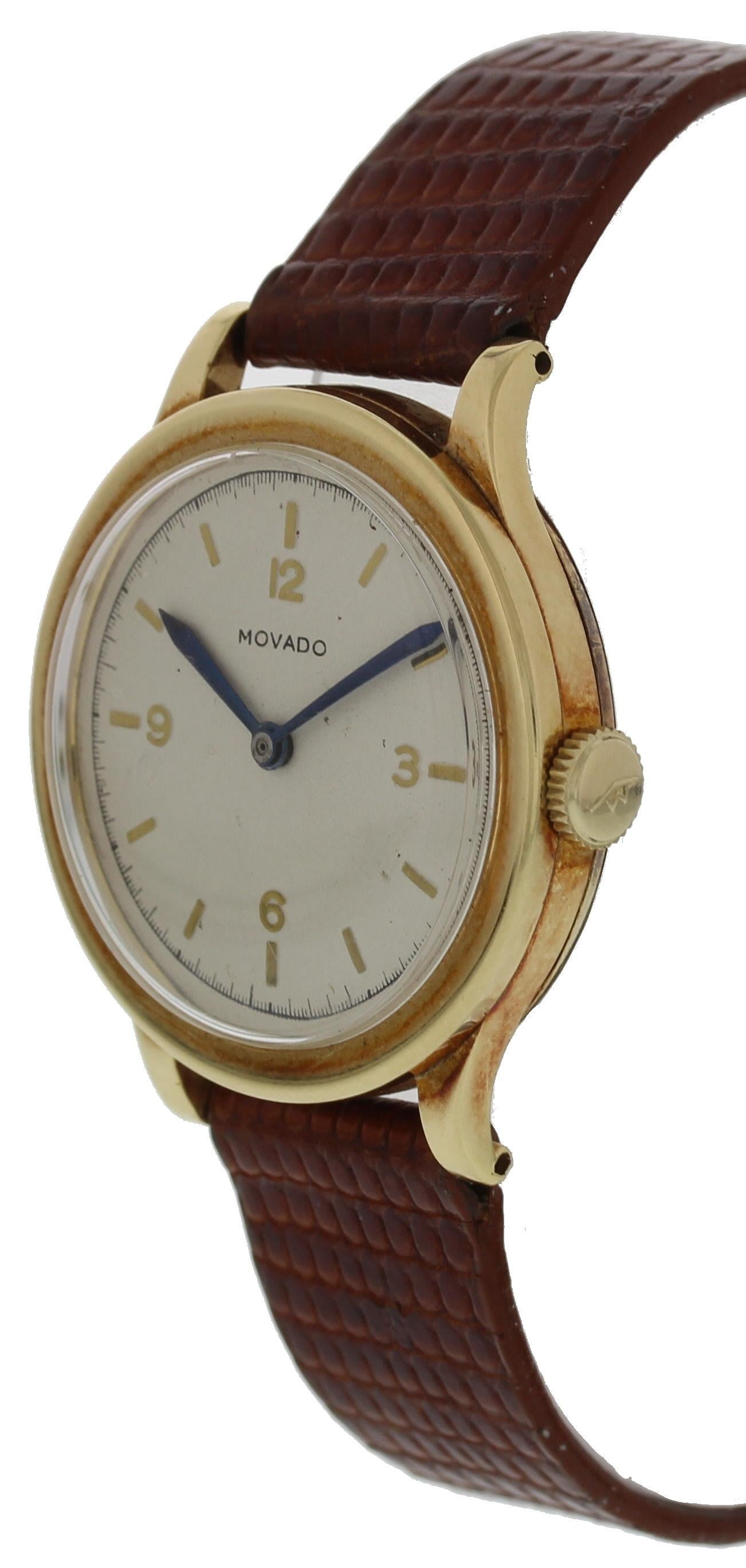 Vintage Movado watch. Gold plated 30mm case. Off white dial with gold colored hour markers and blue hands. Mechanical hand winding movement. 

This watch is backed by our one year warranty. 
