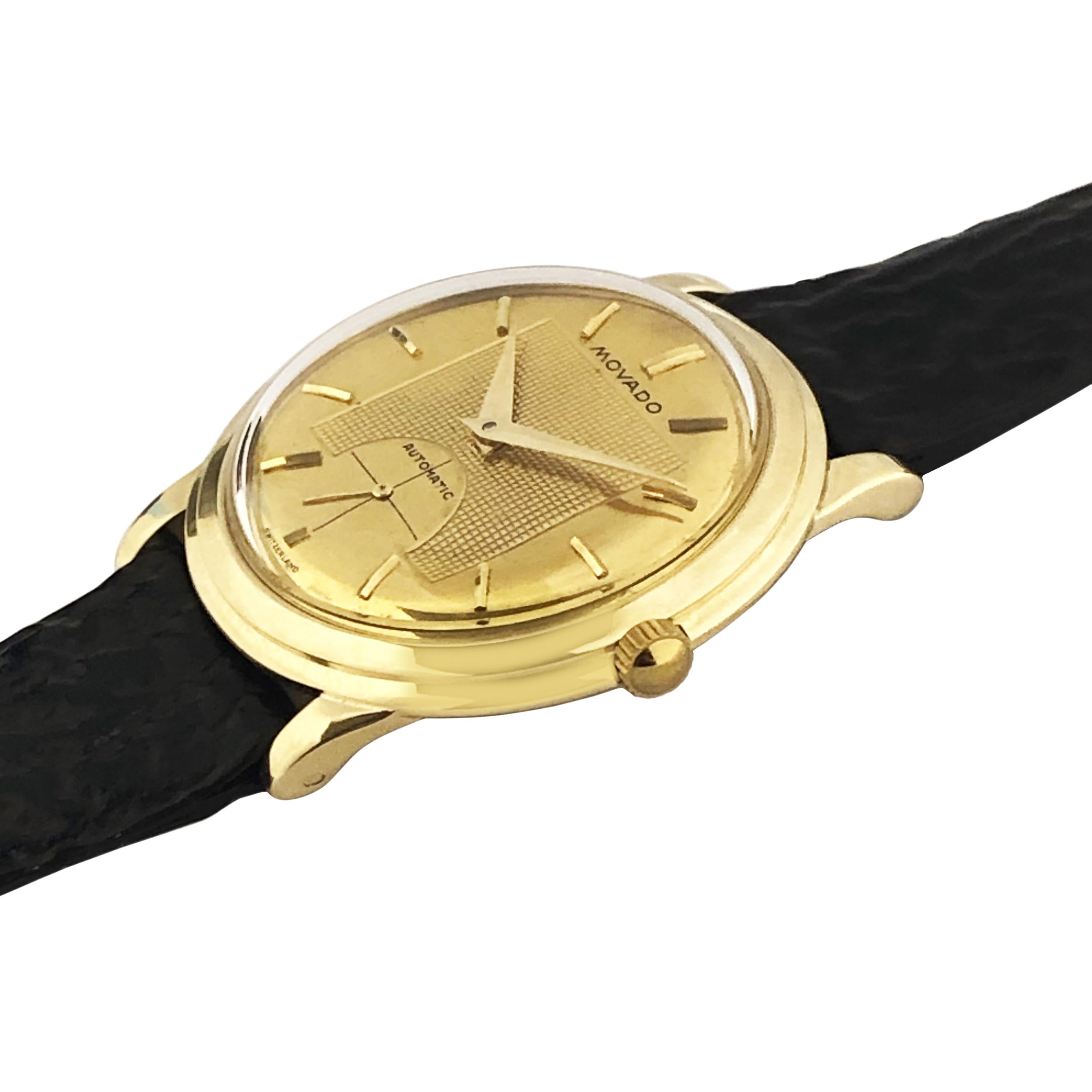 Circa 1960 Movado Kingmatic Wrist watch, 35 M.M. 14K 2 Piece Water proof case, Automatic, self winding movement. Gold Mirrored Dial with Engine cut center dial, raised Gold markers and a sub seconds hand. Original Movado Brown textured strap with