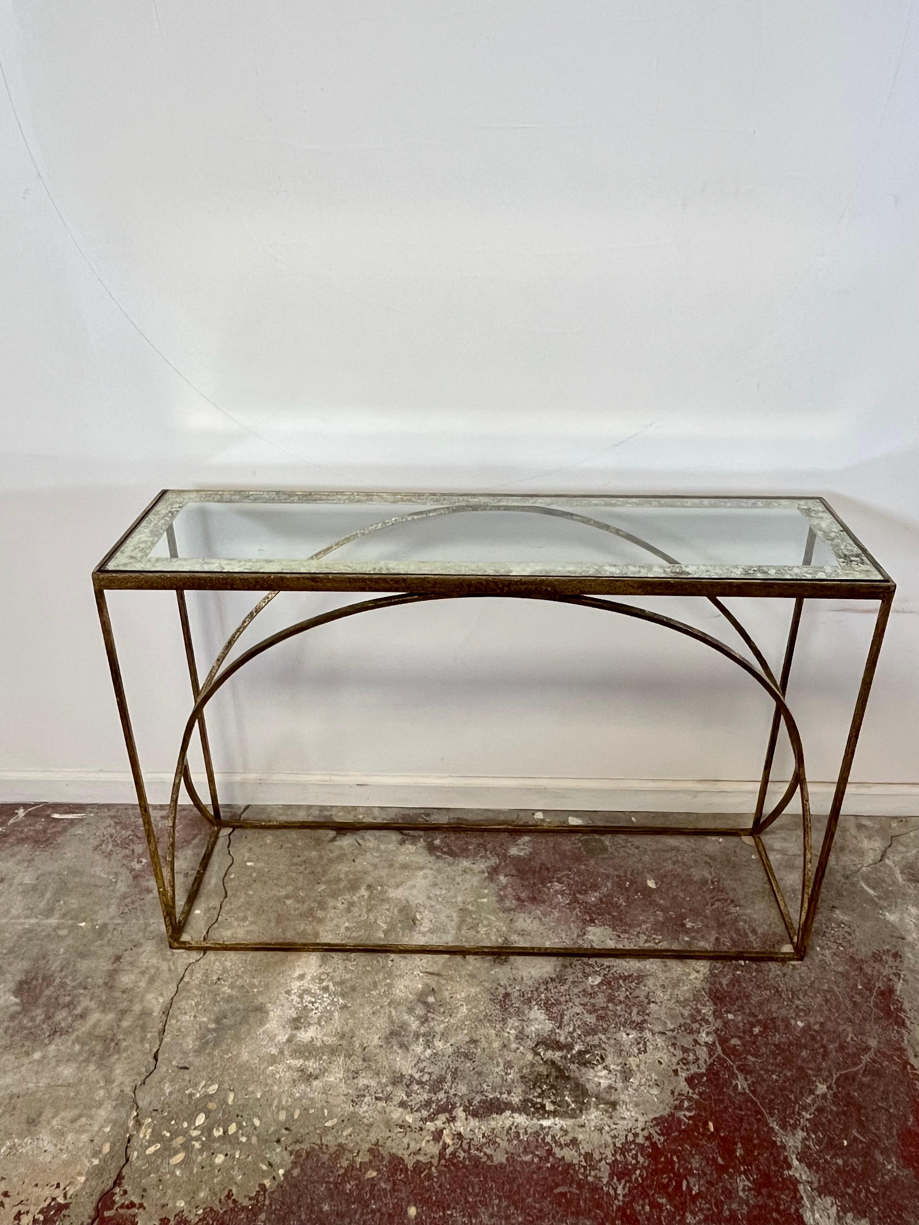 Stunning contemporary console finished in a spectacular forged gilt finish. Ellipse design with a striking glass top with oil drip border.
Curbside to NYC/Philly $400