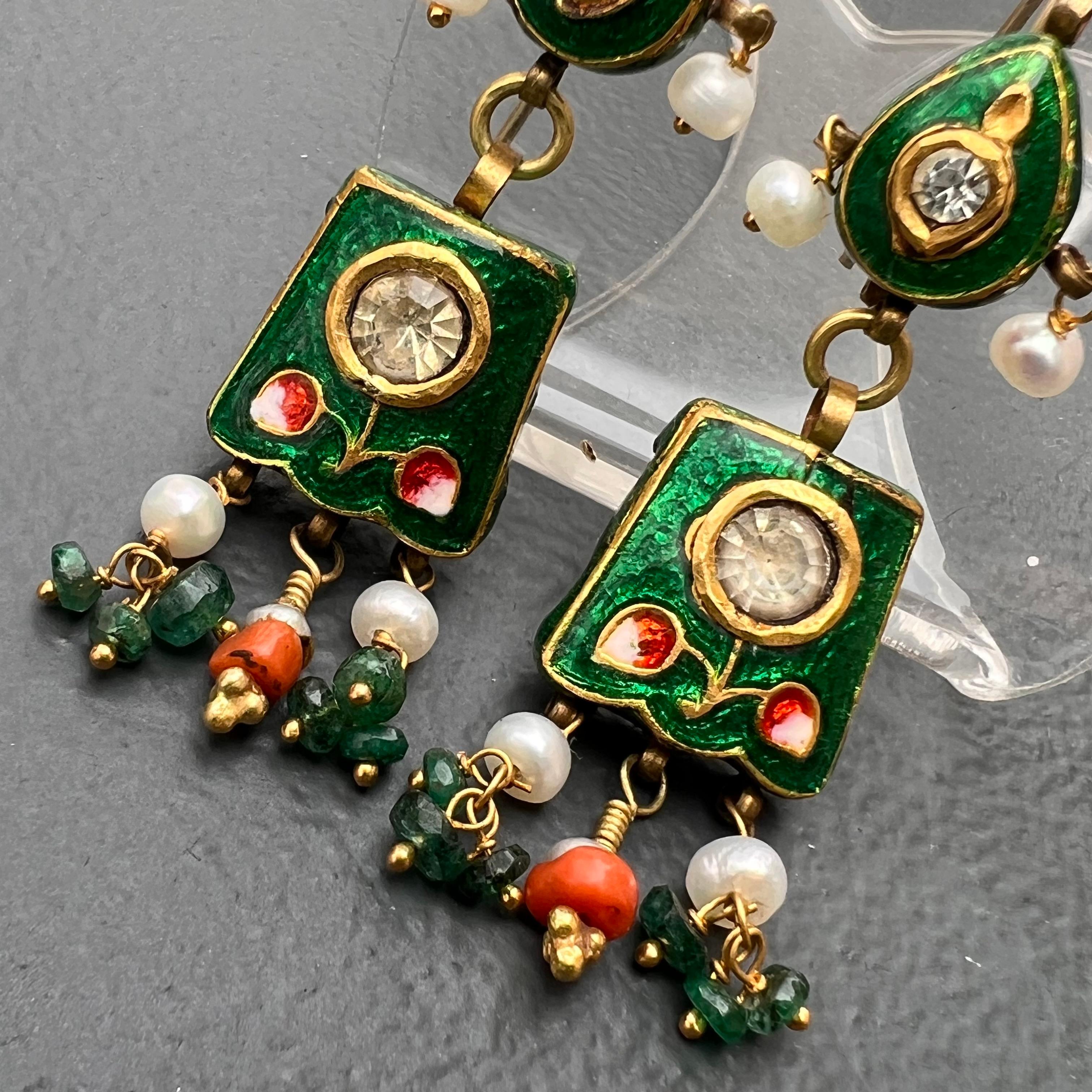 Beautiful vintage 10kt gold , hand - painted Mughal earrings with fresh water cultured pearls , paste stones , coral and emerald beads at bottom . These kundan  style jewelry is handmade  and is wax filled with gold or silver sheet on top as these