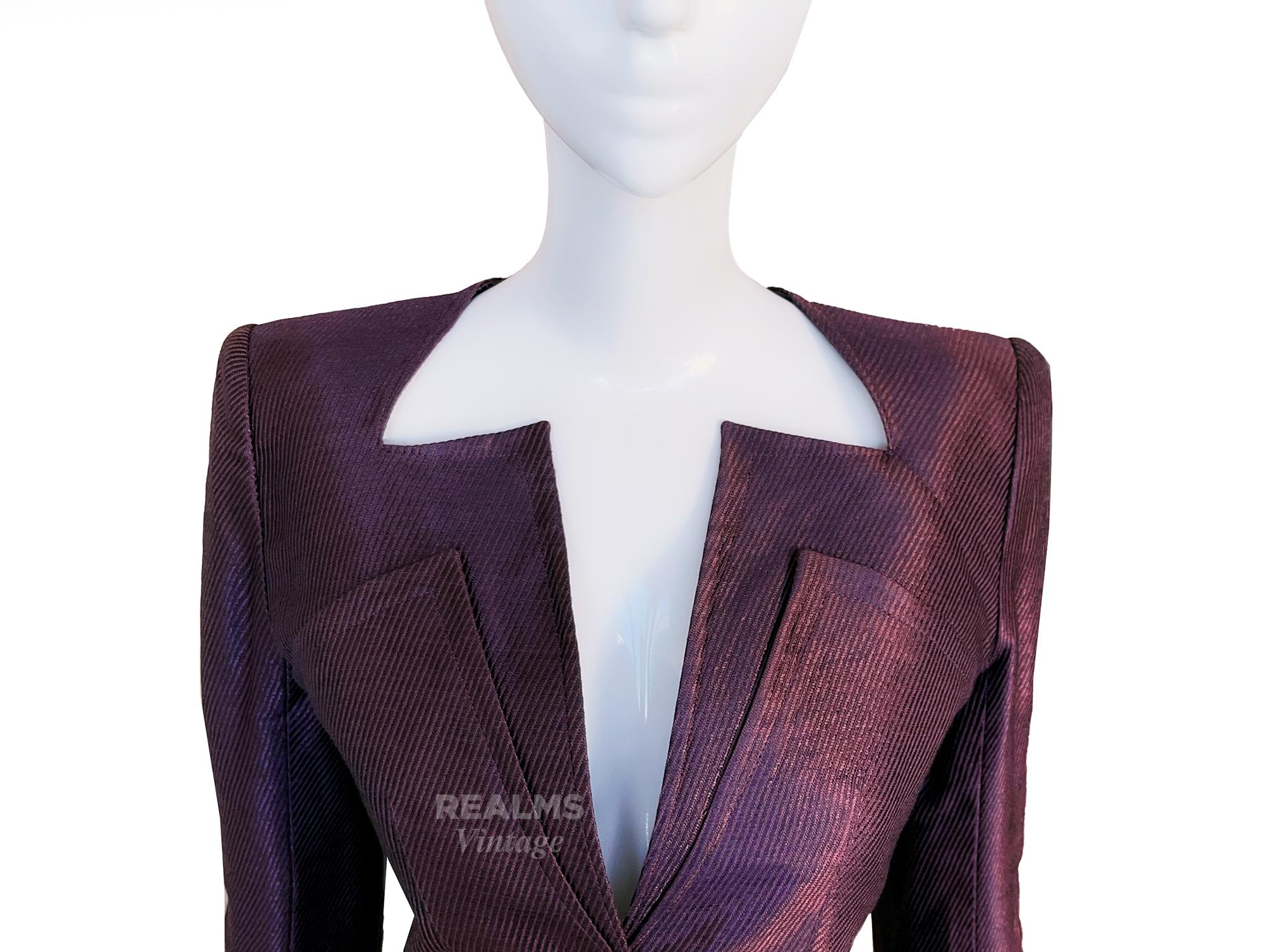 A gorgeous MUGLER creation. Dark purple blazer jacket with amazing avant-garde vibe. Zigzag Cutout Neckline, beautiful Mugleresque construction, feminine fitted shape and shiny silver press buttons at the front.
The colour shade is almost iridescent