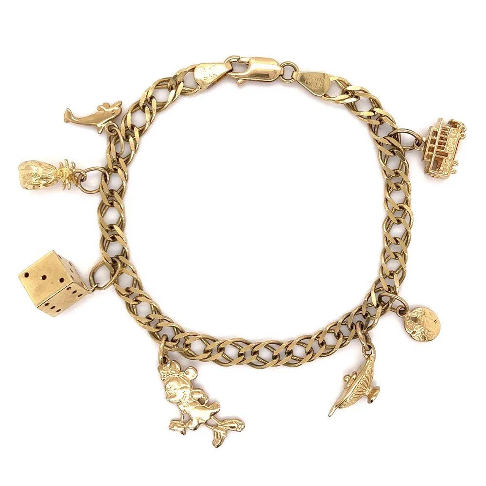Simply Beautiful! Vintage Multi Charm 14K Yellow Gold Multi Charm Bracelet, showcasing Minnie Mouse, a Dolphin, Pineapple, Dice, Genie Lamp, Sand Dollar and Cable Car. Approx. 7” Long. Chic and Fun to Wear! More Beautiful in real time! Sure to be