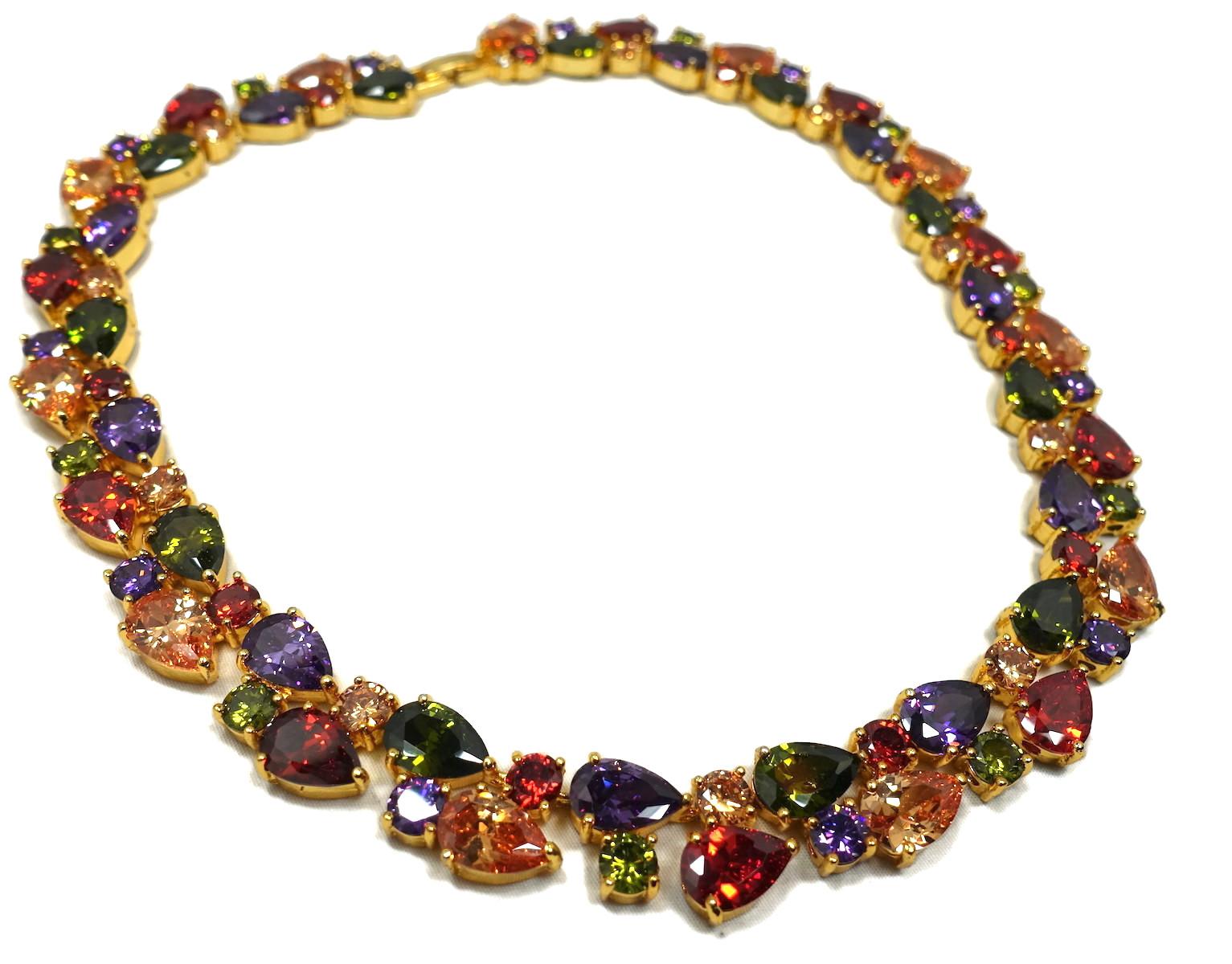 This vintage 1970s necklace features multi-color crystals in a gold tone setting.  In excellent condition, this necklace measures 17” x 5/8” and has a fold-over clasp.