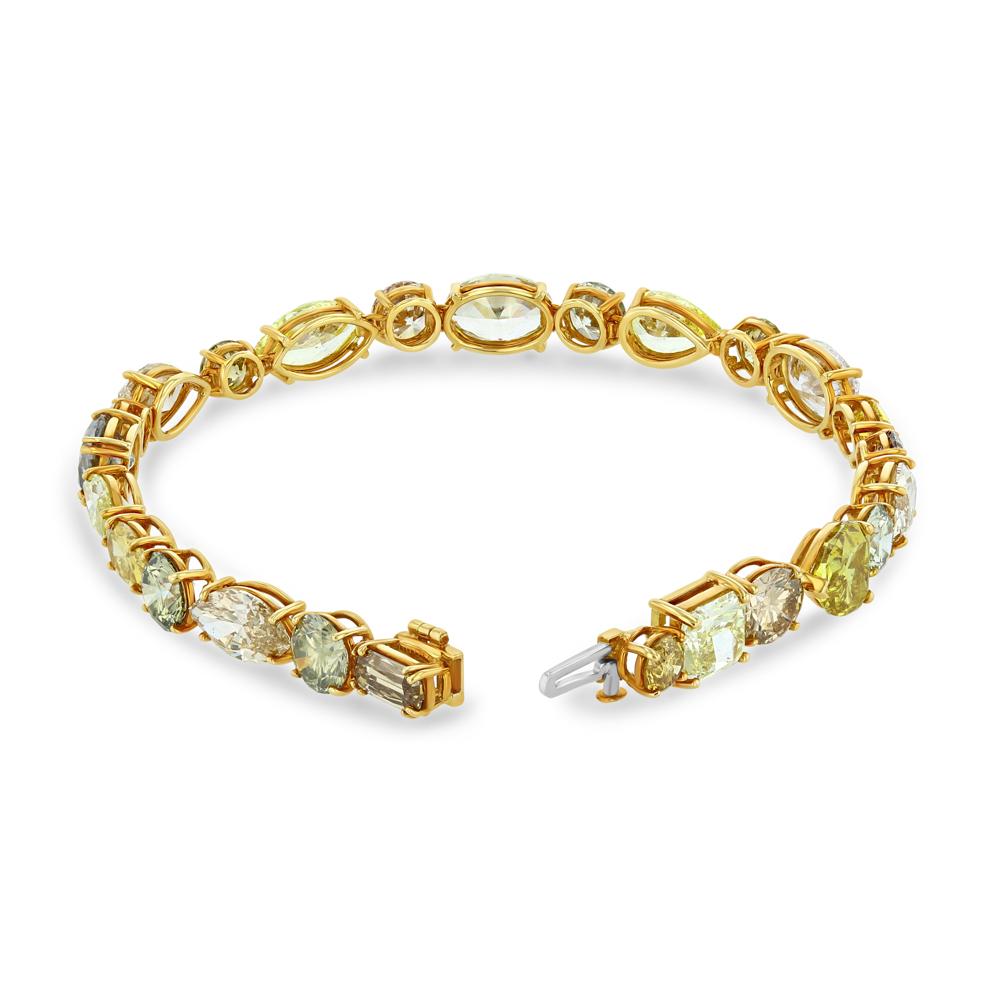 25 diamonds, varying in shape and natural color, create a breathtaking 7 inch bracelet. This extraordinary bracelet is ethereal! All of the diamonds have certificates.